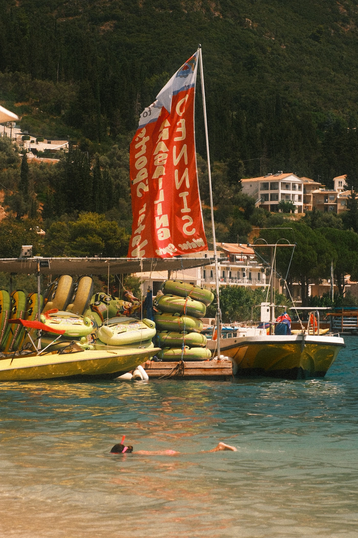 Real snorkeling scene in clear water near kayaks and water recreation equipment