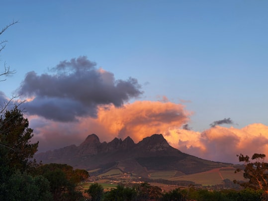 Mountain peaks under a lit evening cloud