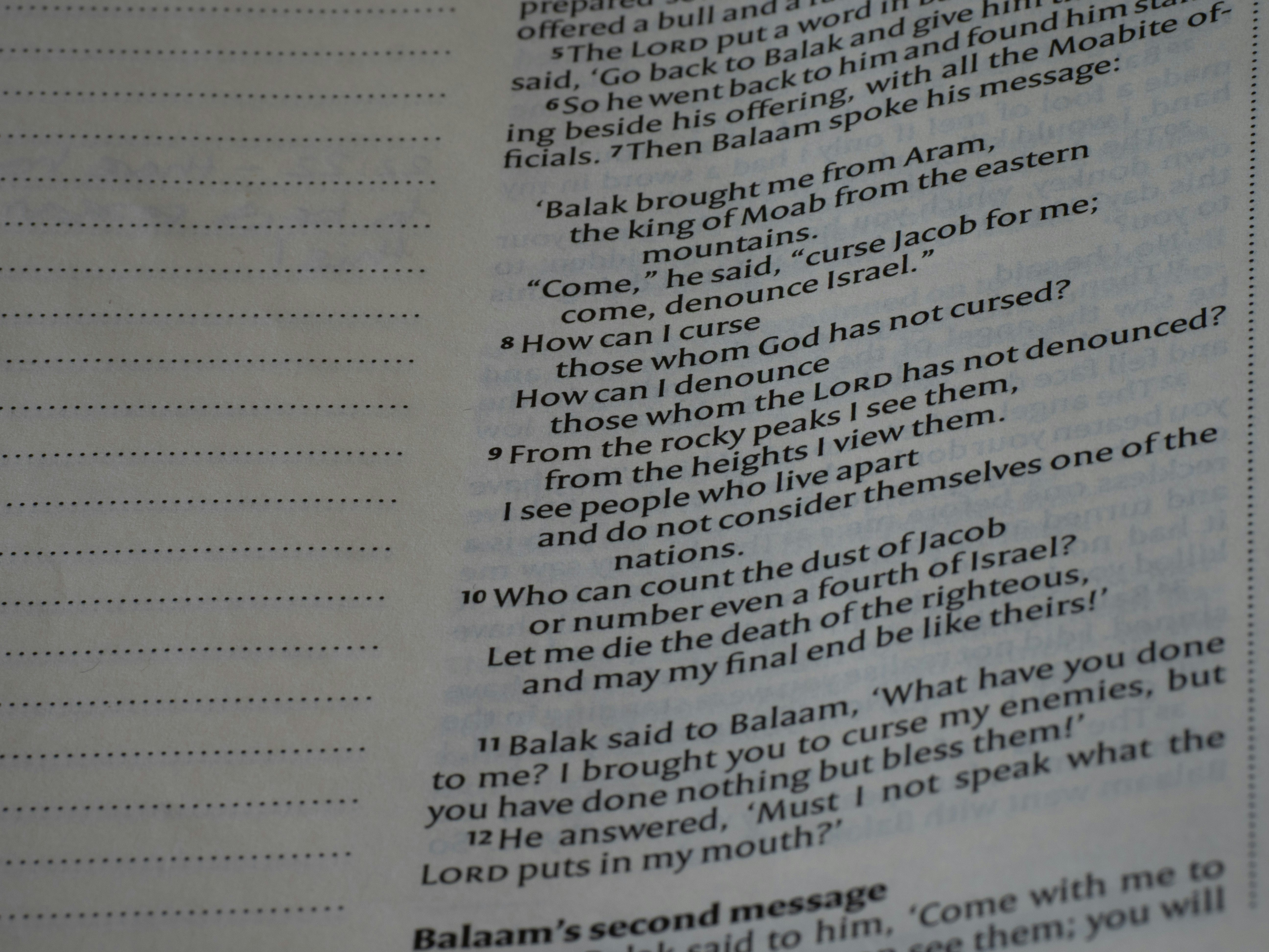 Printed text from a religious book with numbered verses on a page.