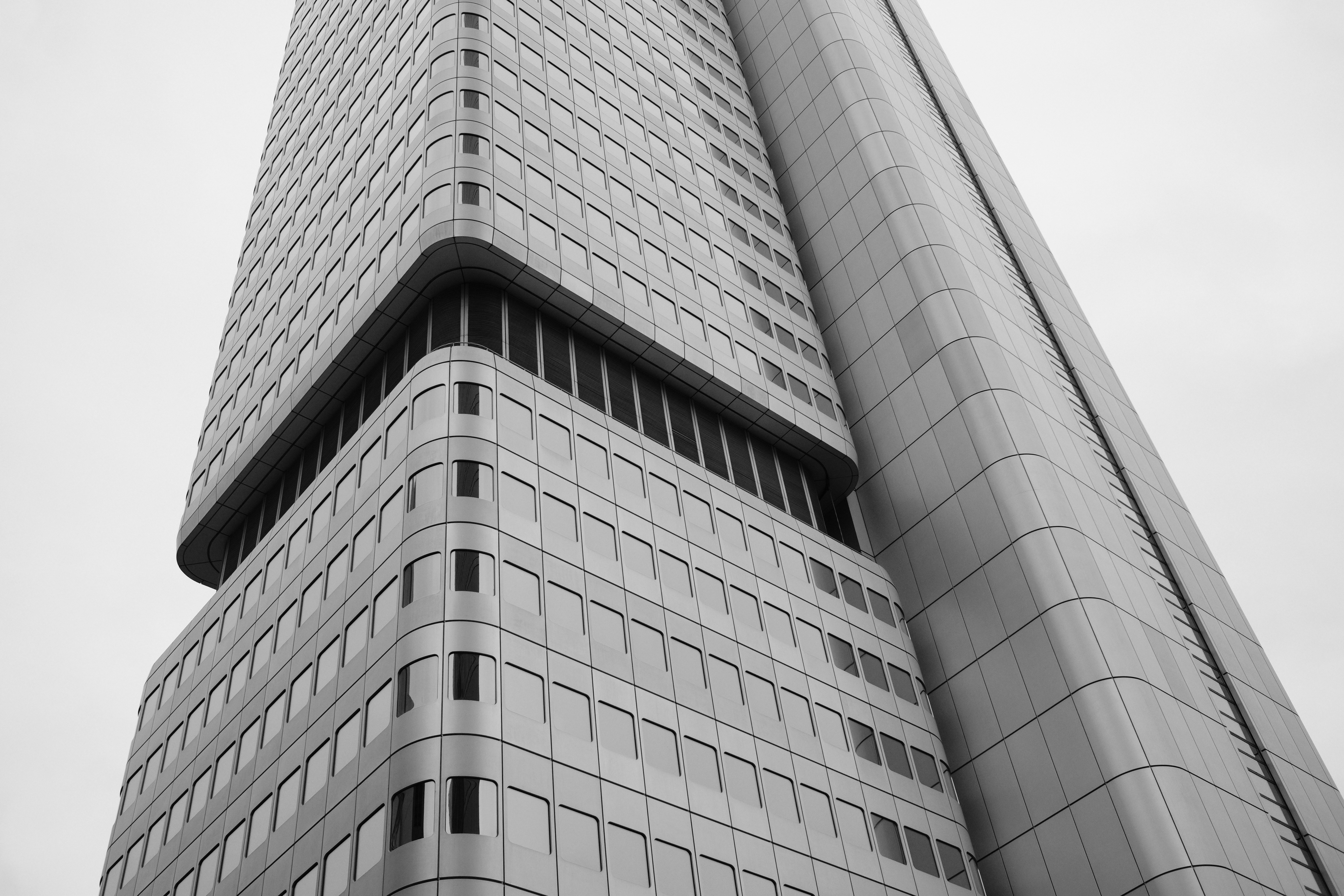 A low-angle view of a modern skyscraper with a grid of windows