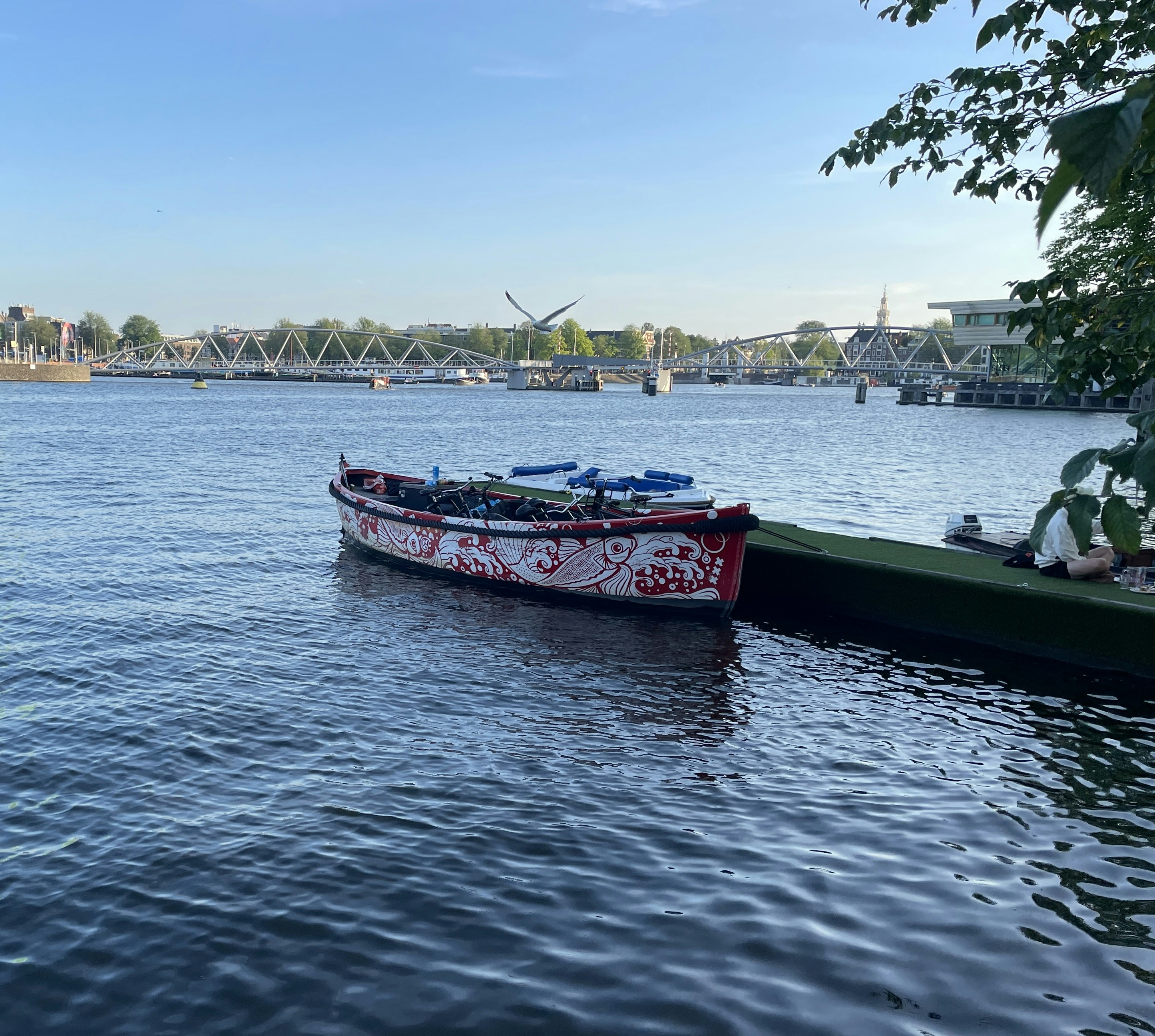 A red and white patterned boat moored at a dock in Amsterdam