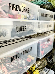 Clear plastic storage bins with black labels on a metal wire shelving unit