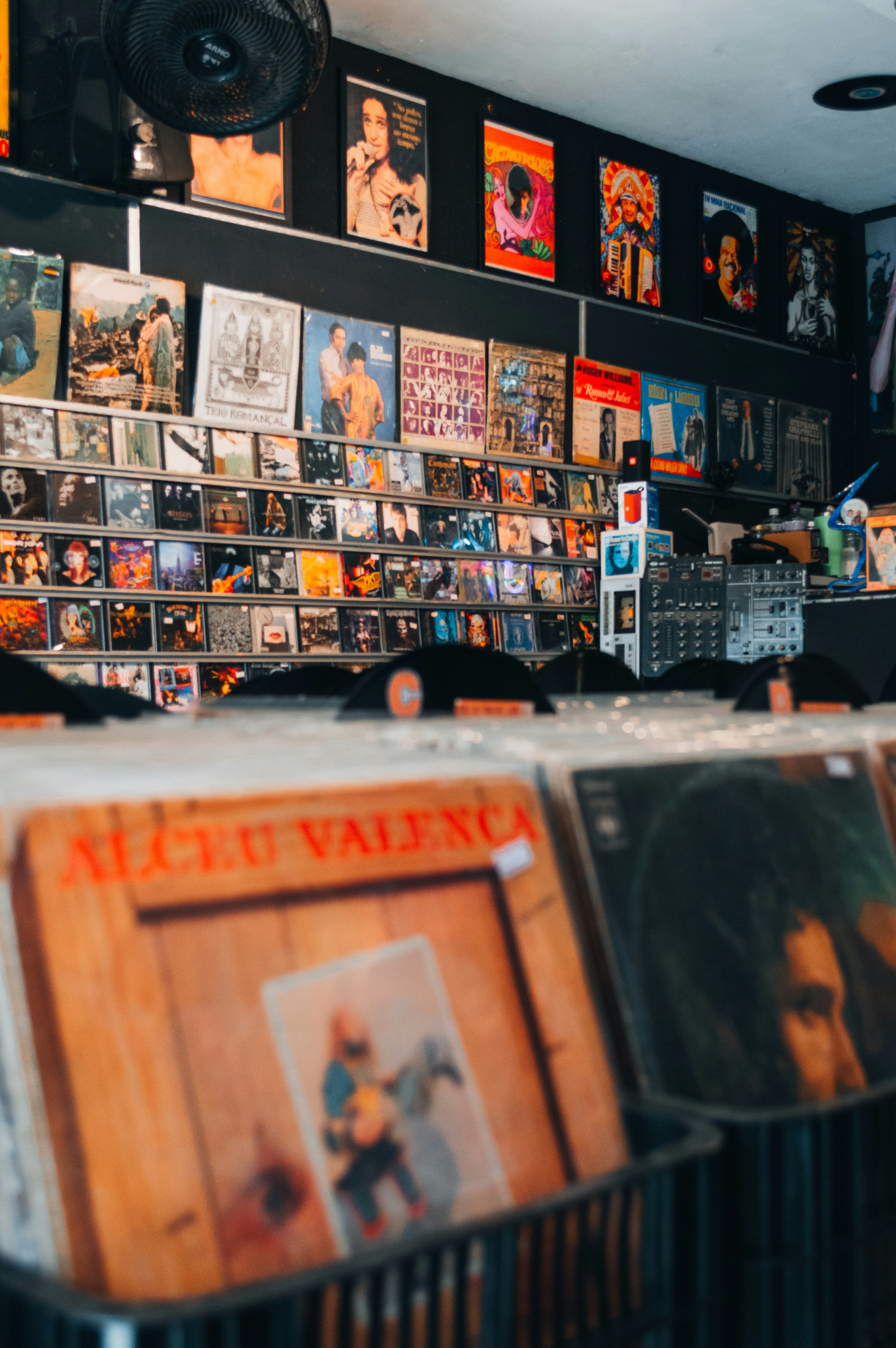 Vinyl records in crates and on display shelves in a music store.