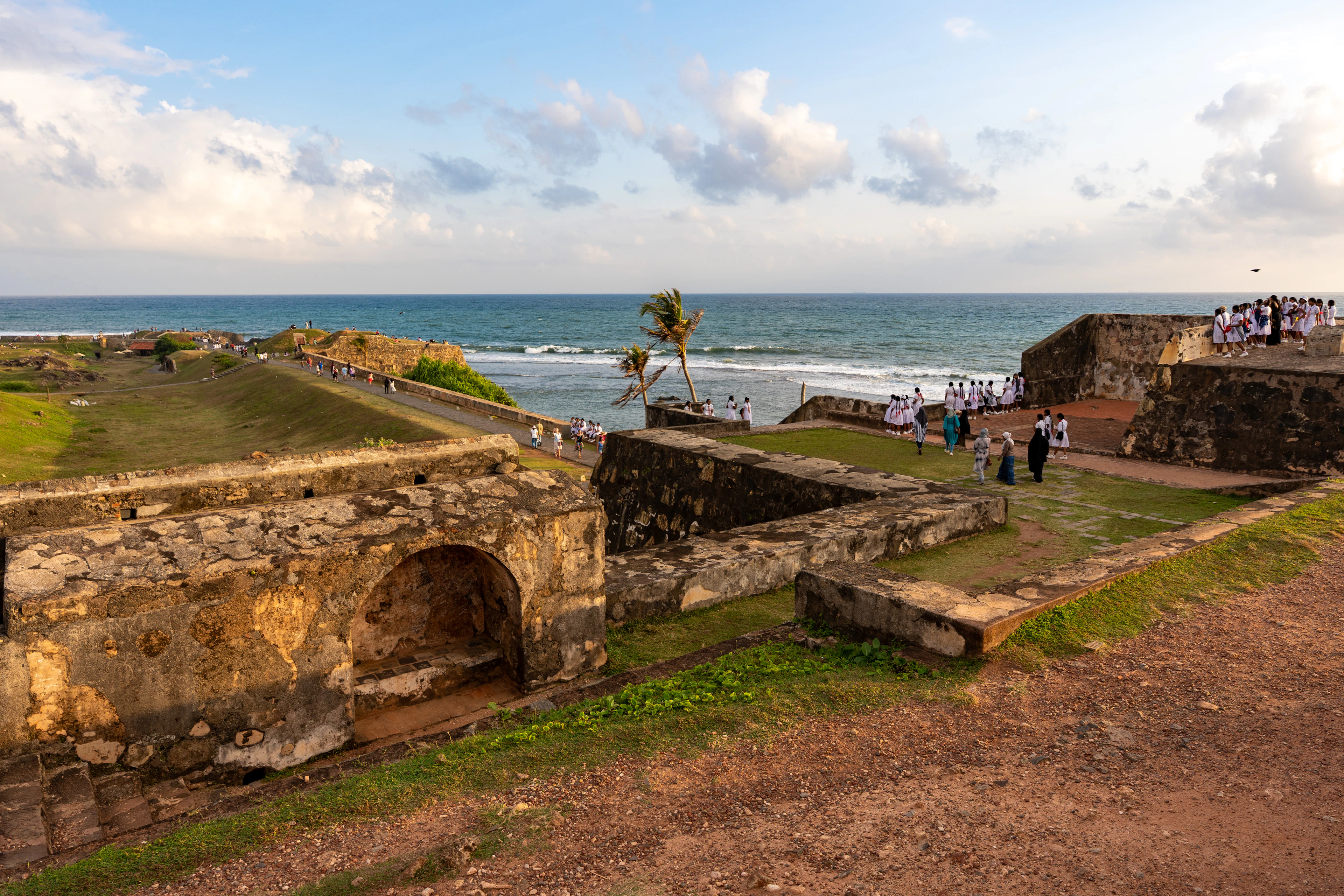 Tourists walking through historic stone fort ramparts