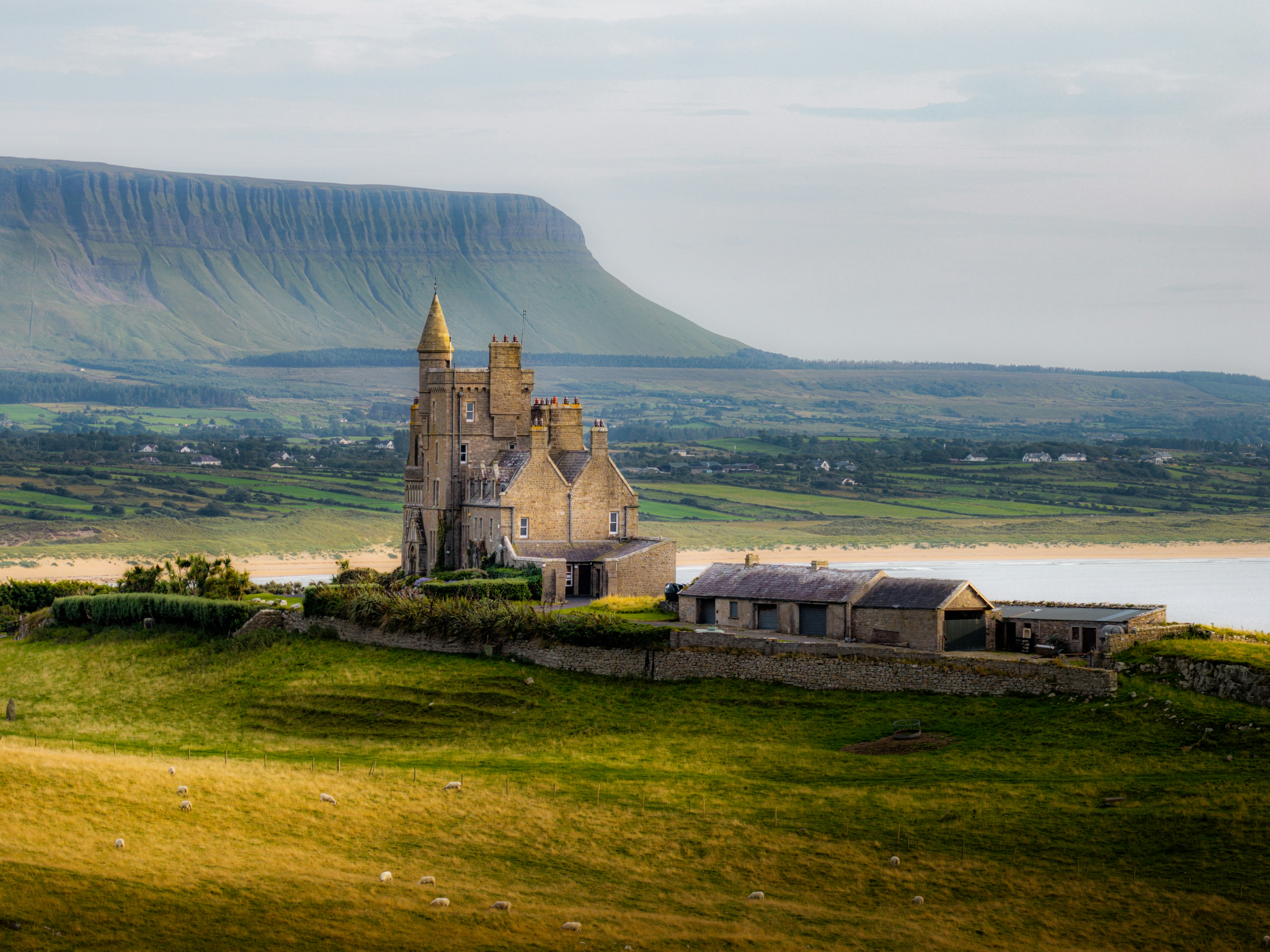 Classiebawn Castle on a grassy cliff overlooking the Atlantic Ocean in County Sligo, Ireland