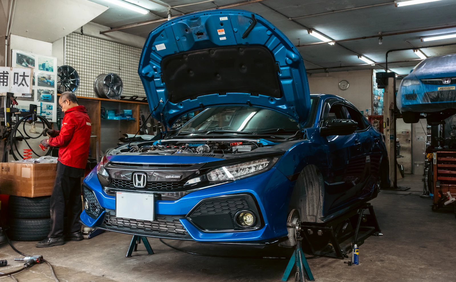 Mechanic working on a car in a garage