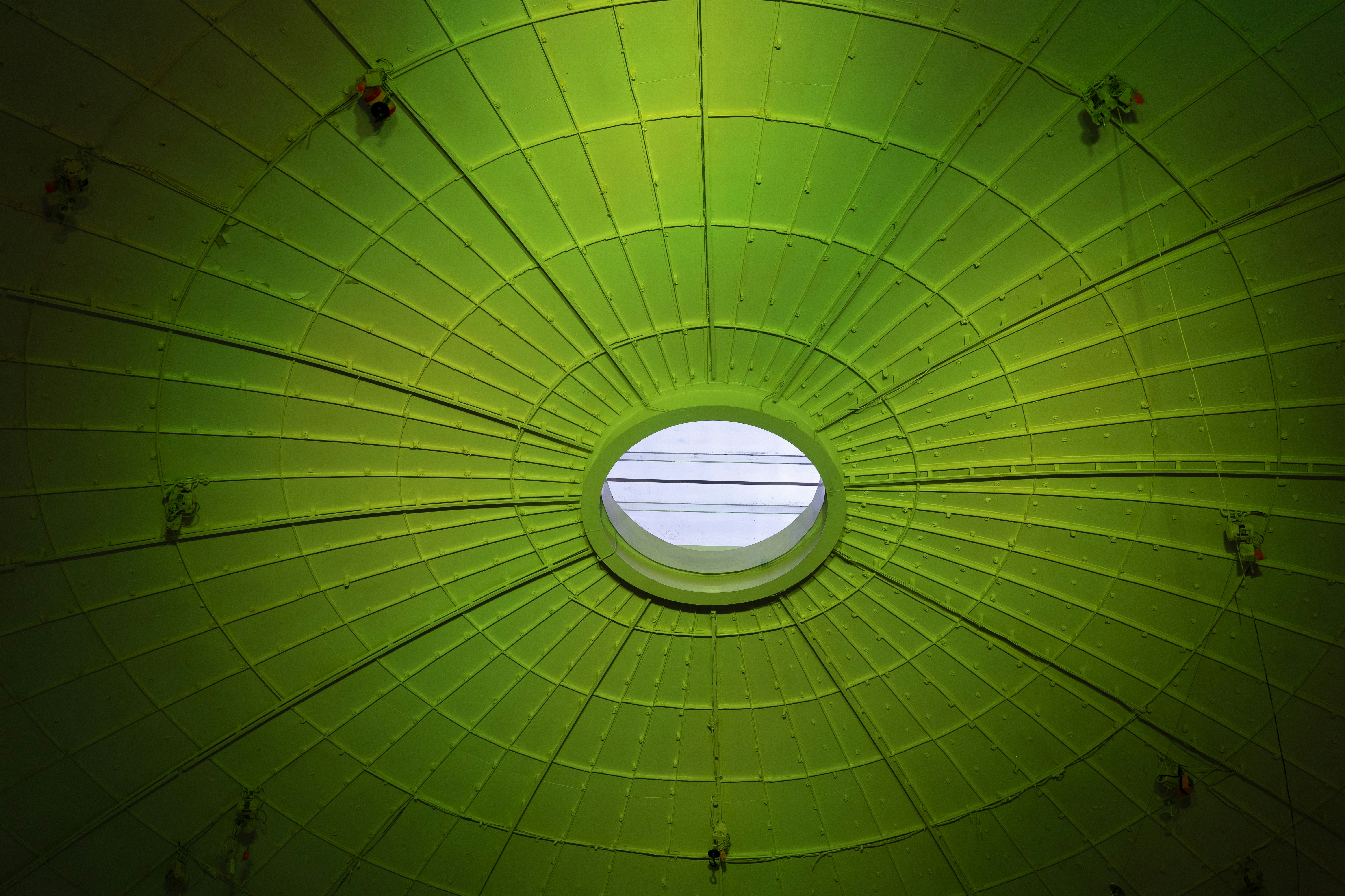 A lime green domed ceiling with a central circular skylight.