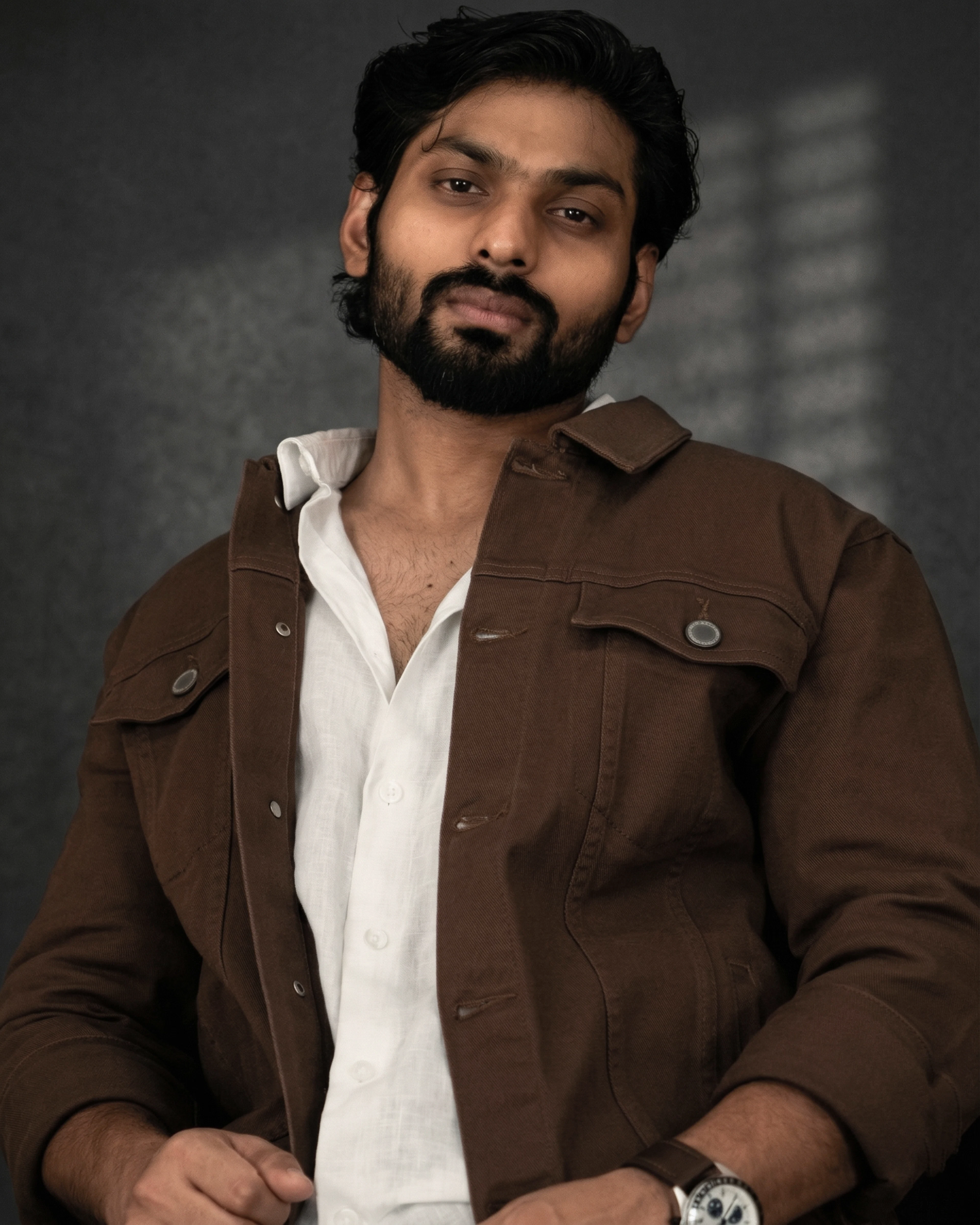 Man wearing a chocolate brown twill overshirt over a white shirt