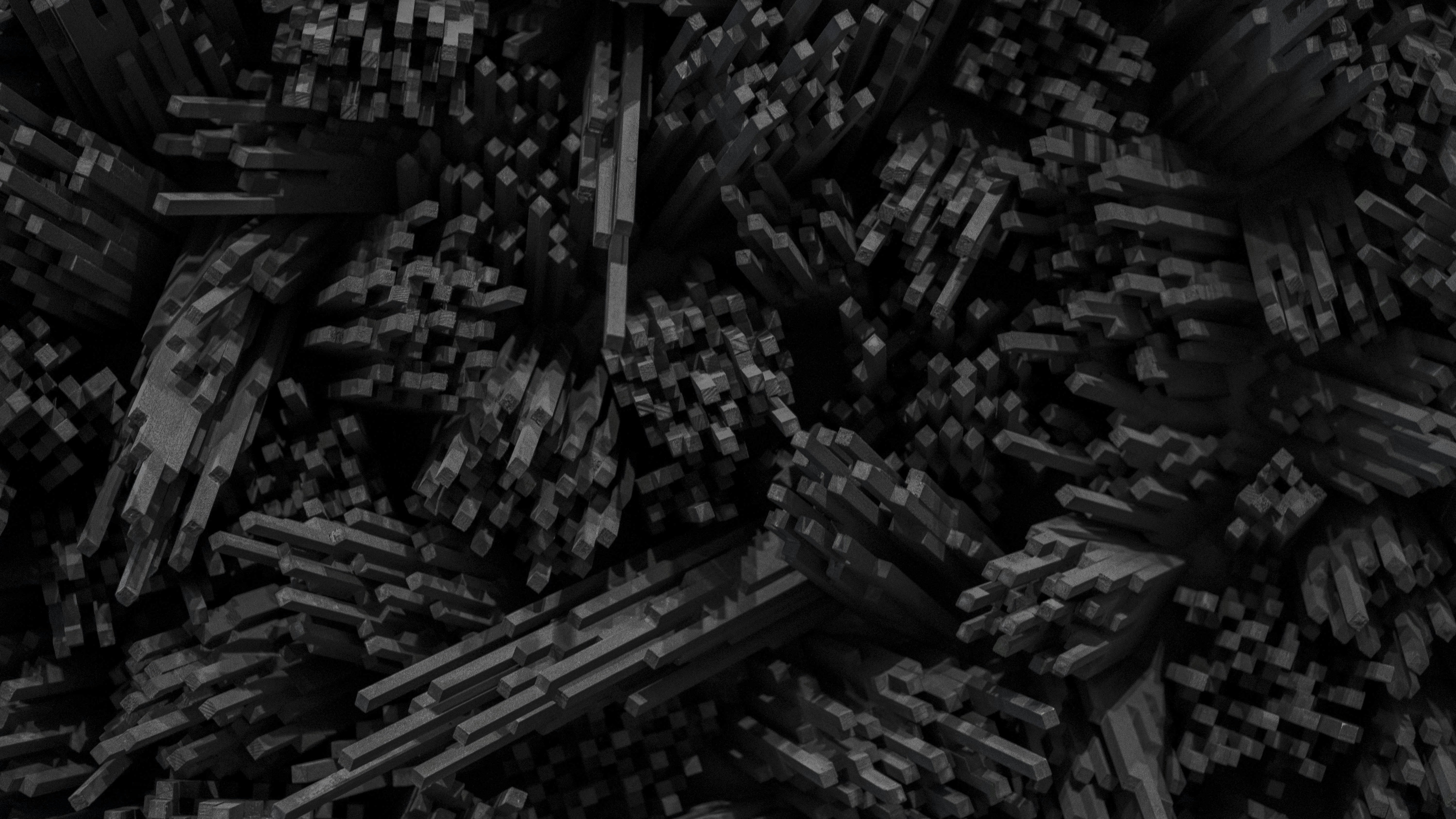 A dense cluster of dark grey rectangular pillars of varying heights and lengths