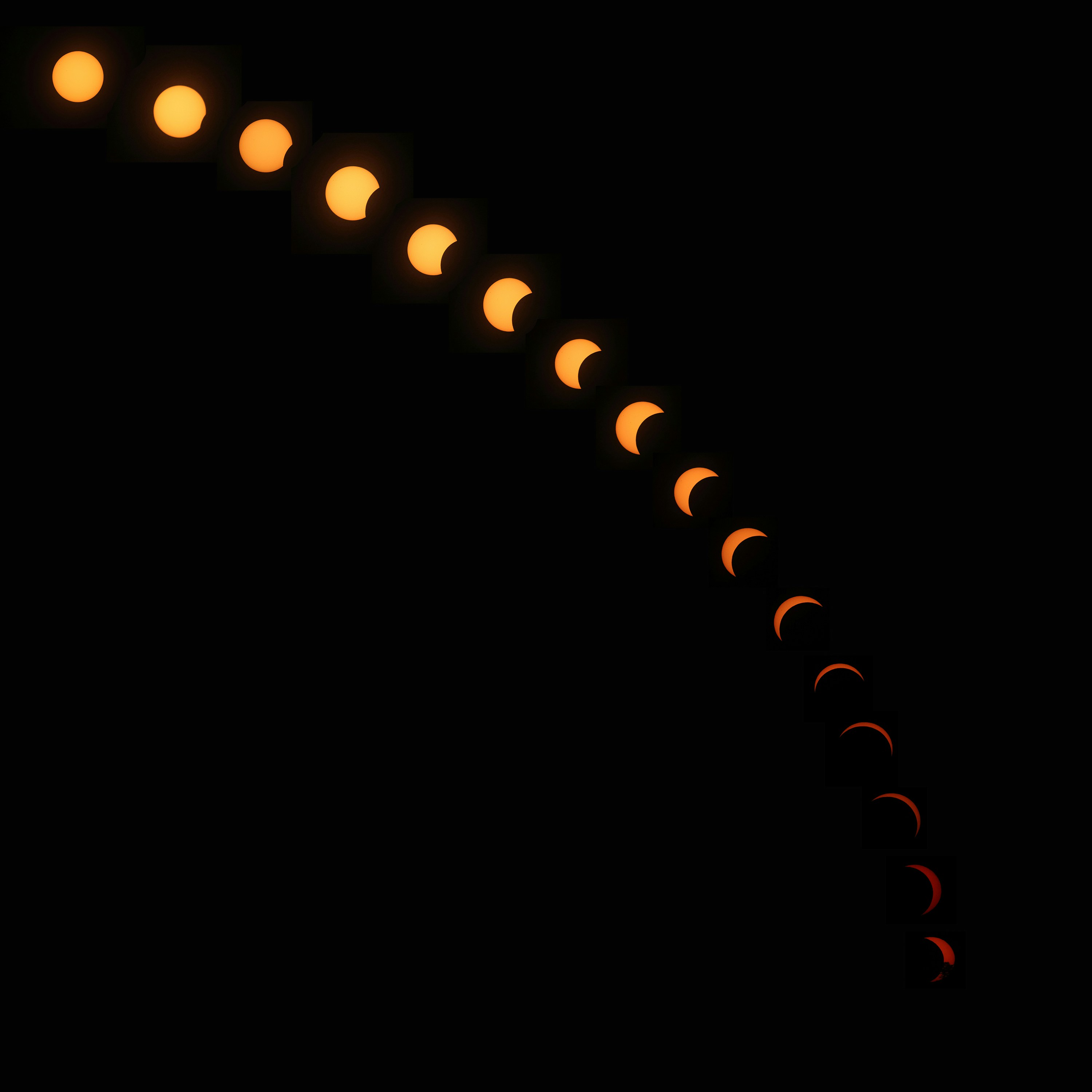 A sequence of solar eclipse phases forming an arc against a black background