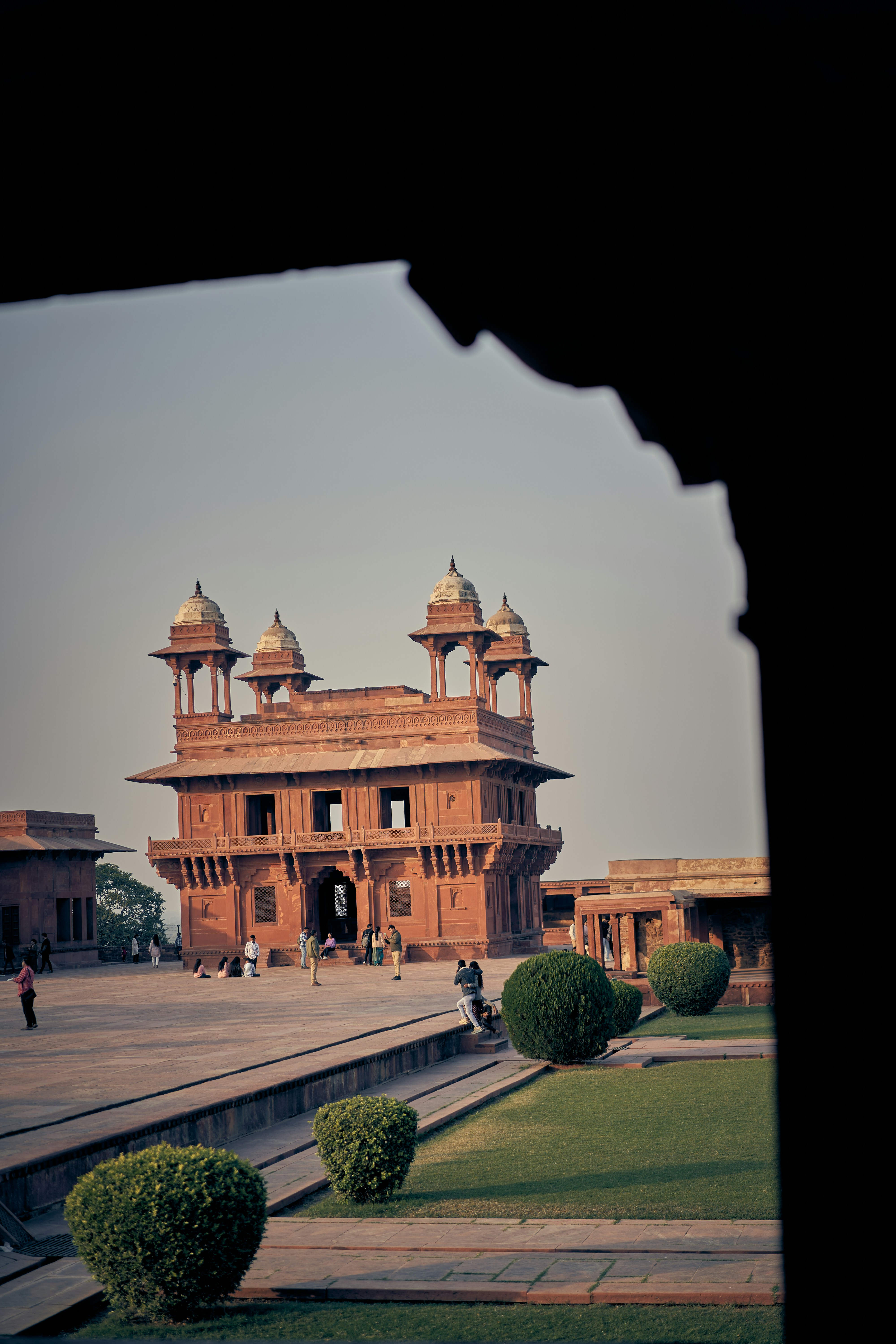 People walking in the courtyard of the Diwan-i-Khas at Fatehpur Sikri in India.