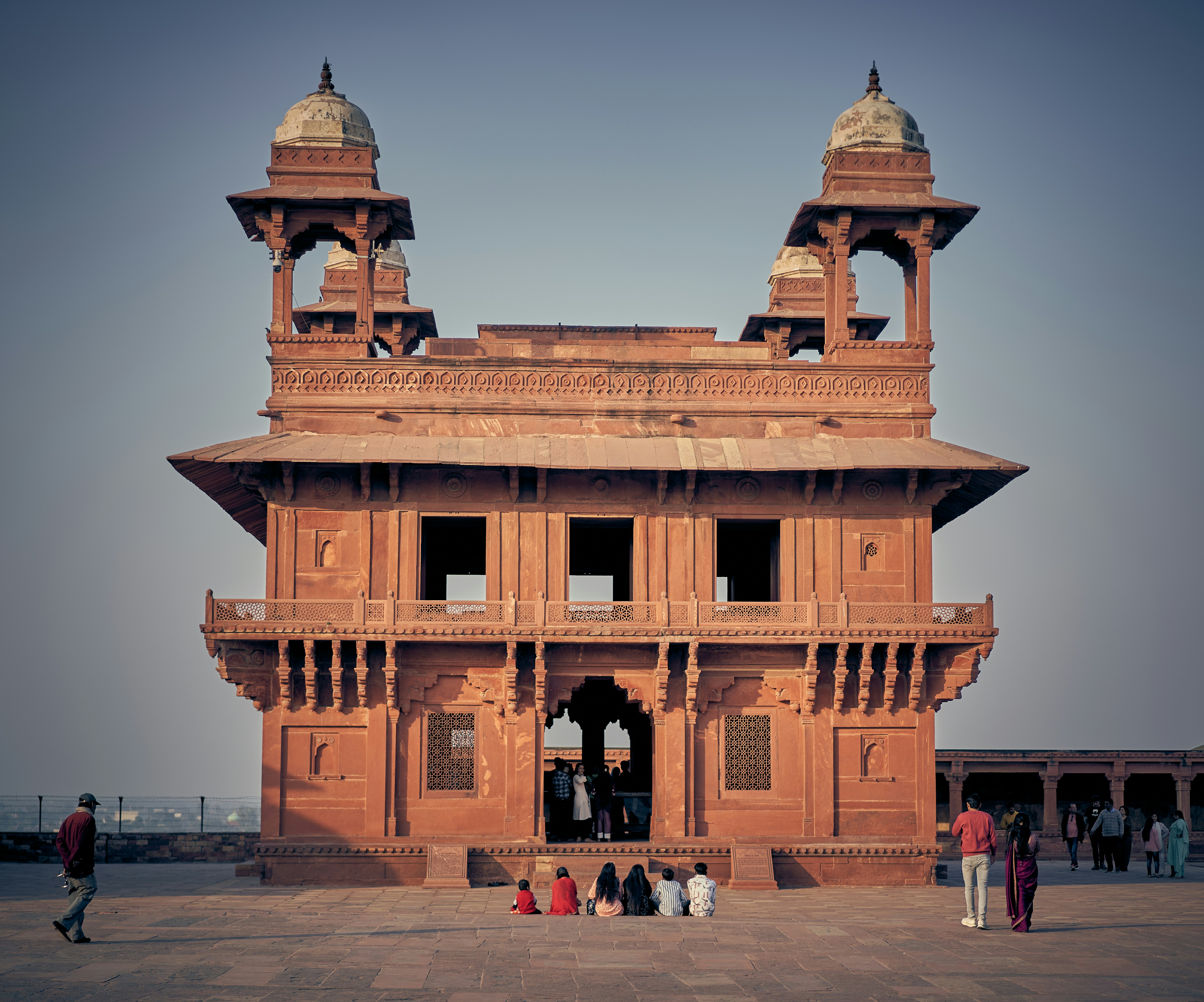 People visiting the red sandstone Diwan-i-Khas building at Fatehpur Sikri in India.