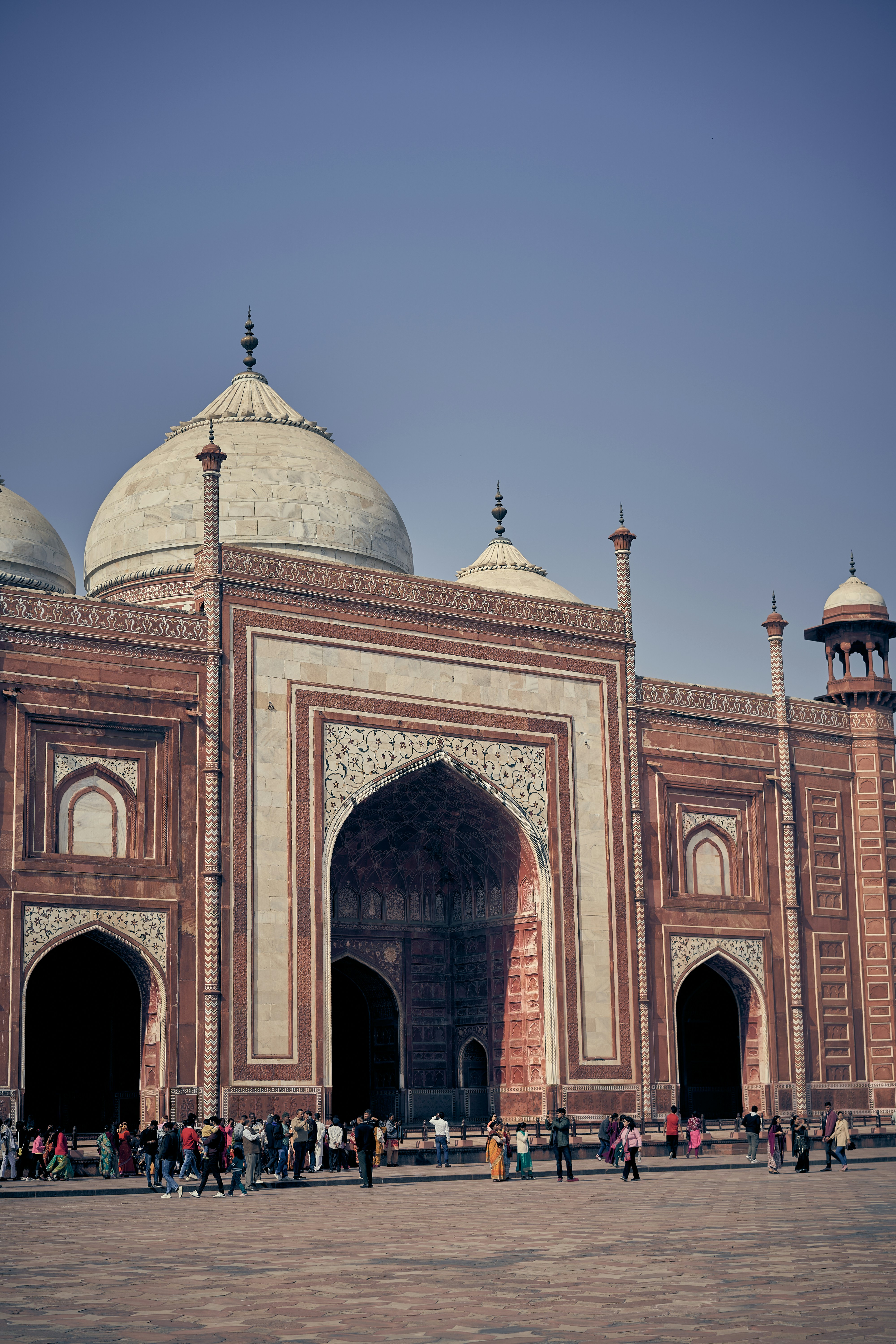 People walking in front of the Taj Mahal in Agra, India.