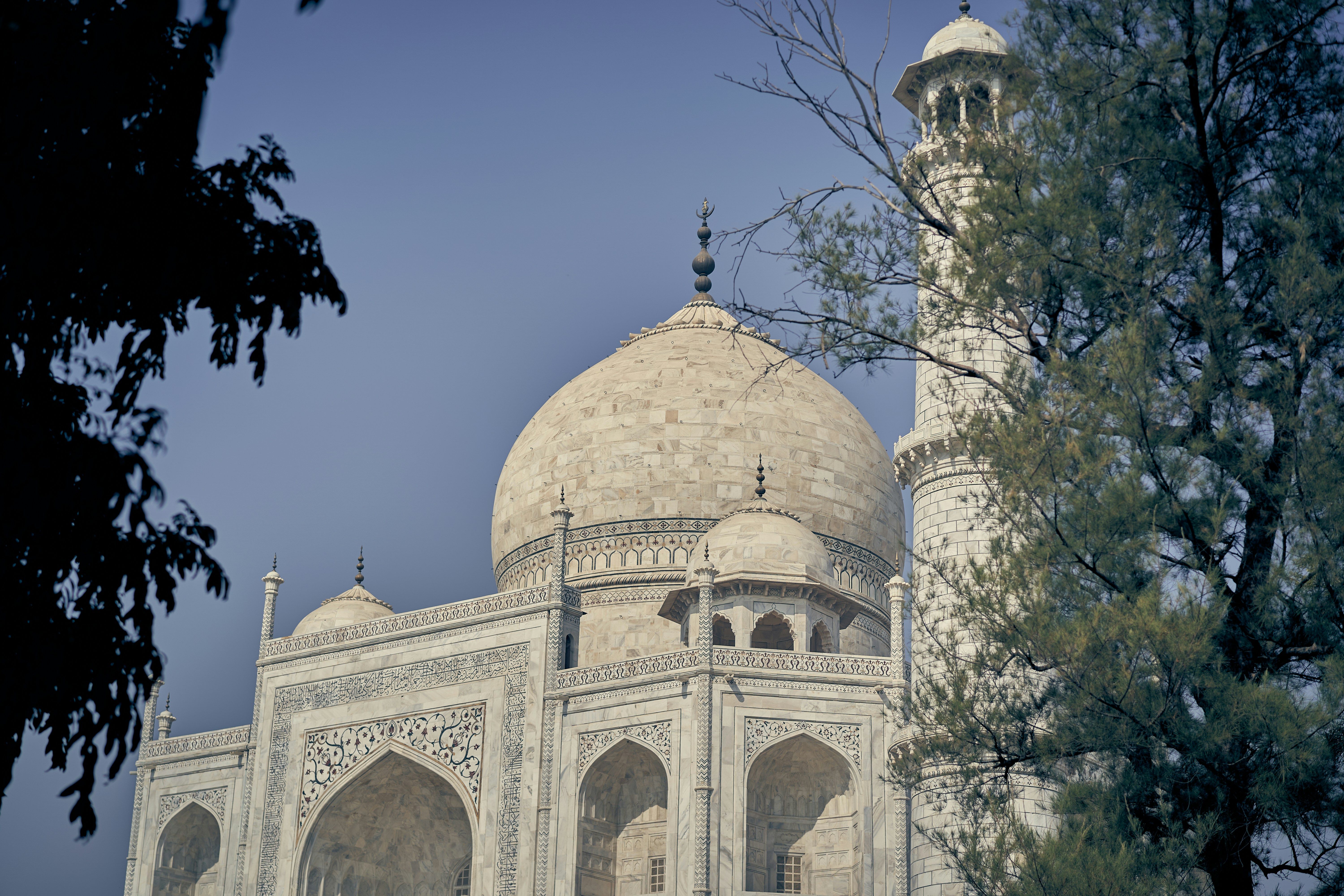 The white marble dome and minaret of the Taj Mahal in Agra, India.