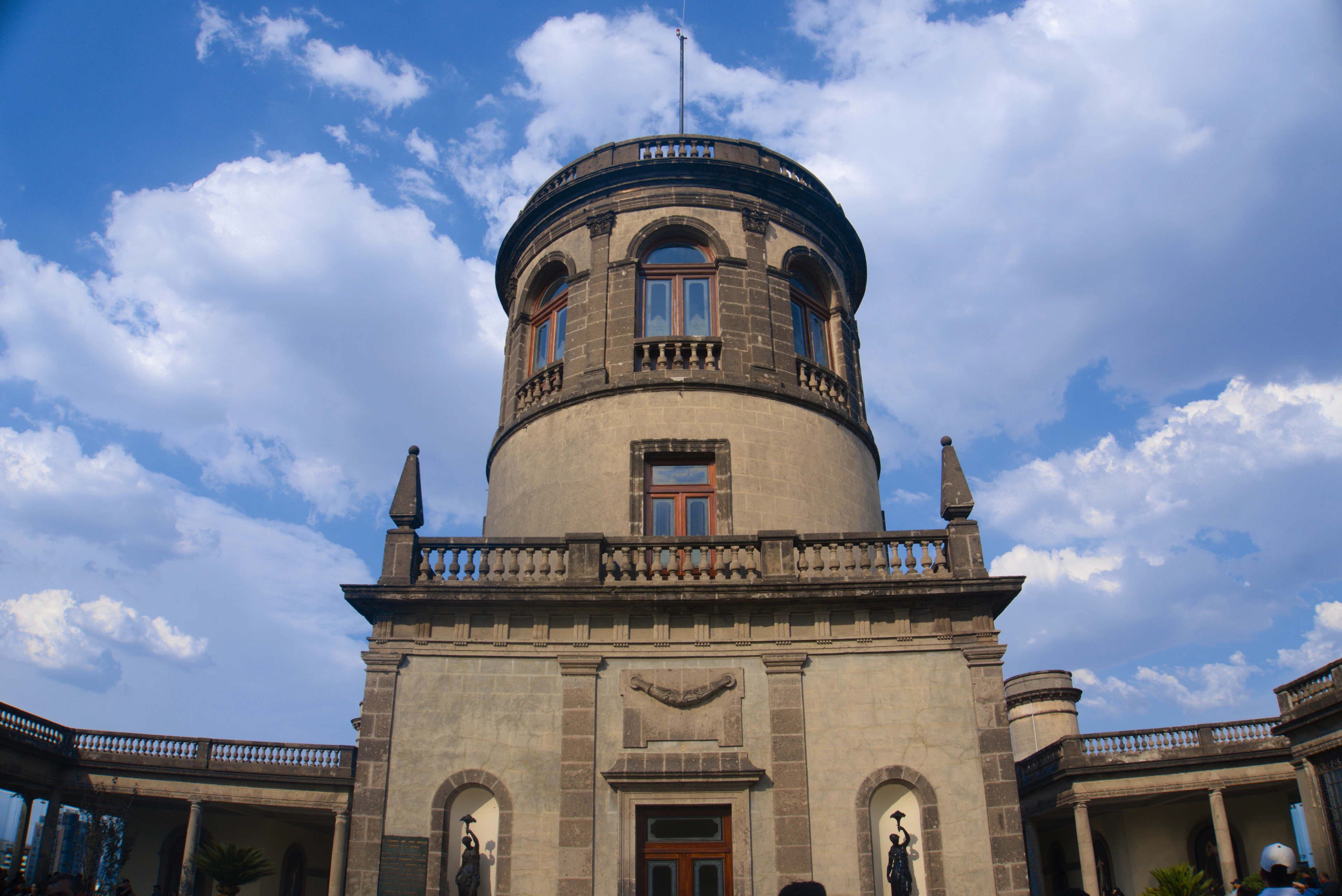 The stone tower of Chapultepec Castle above its surrounding park in Mexico City