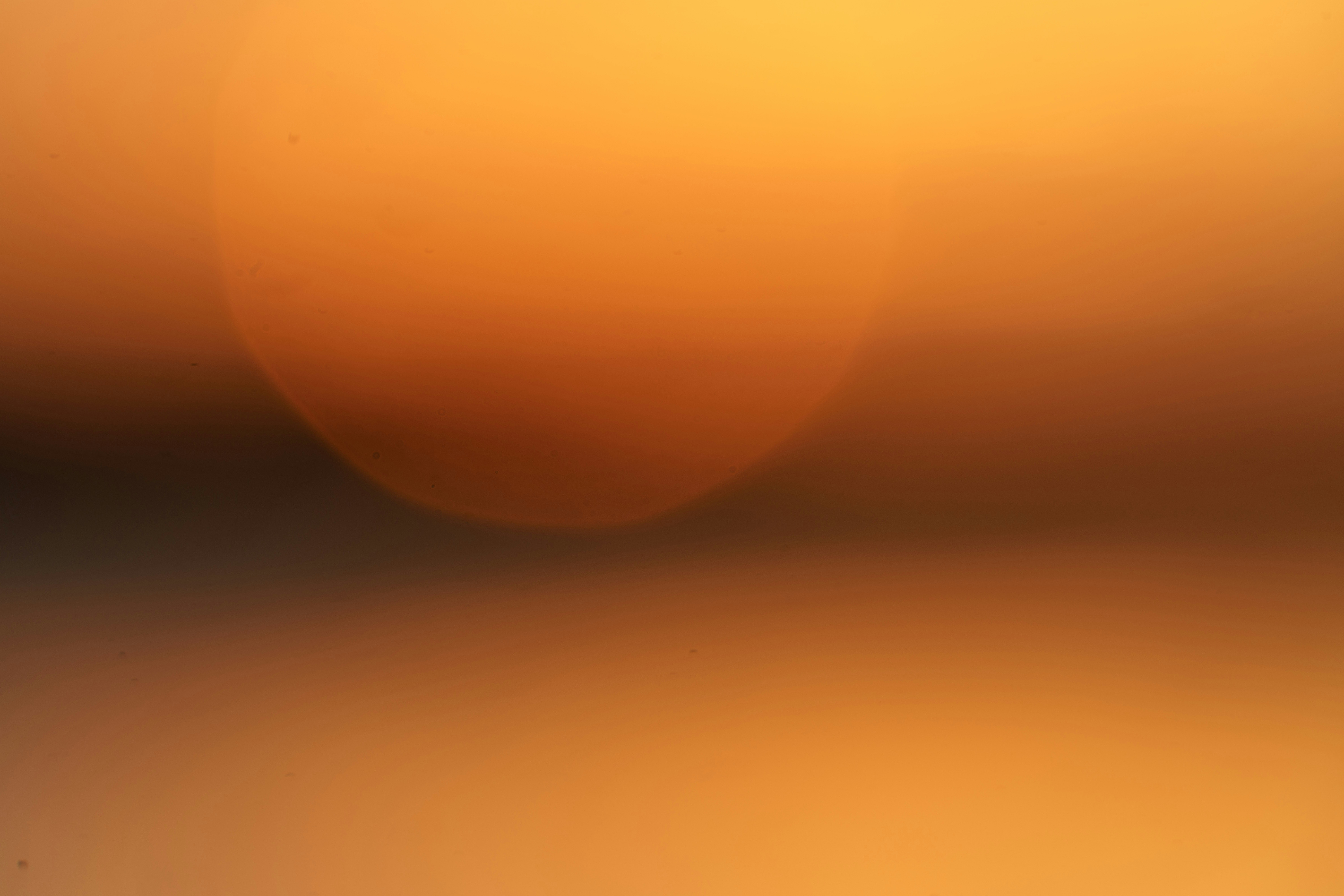 A soft out of focus circle of warm orange light