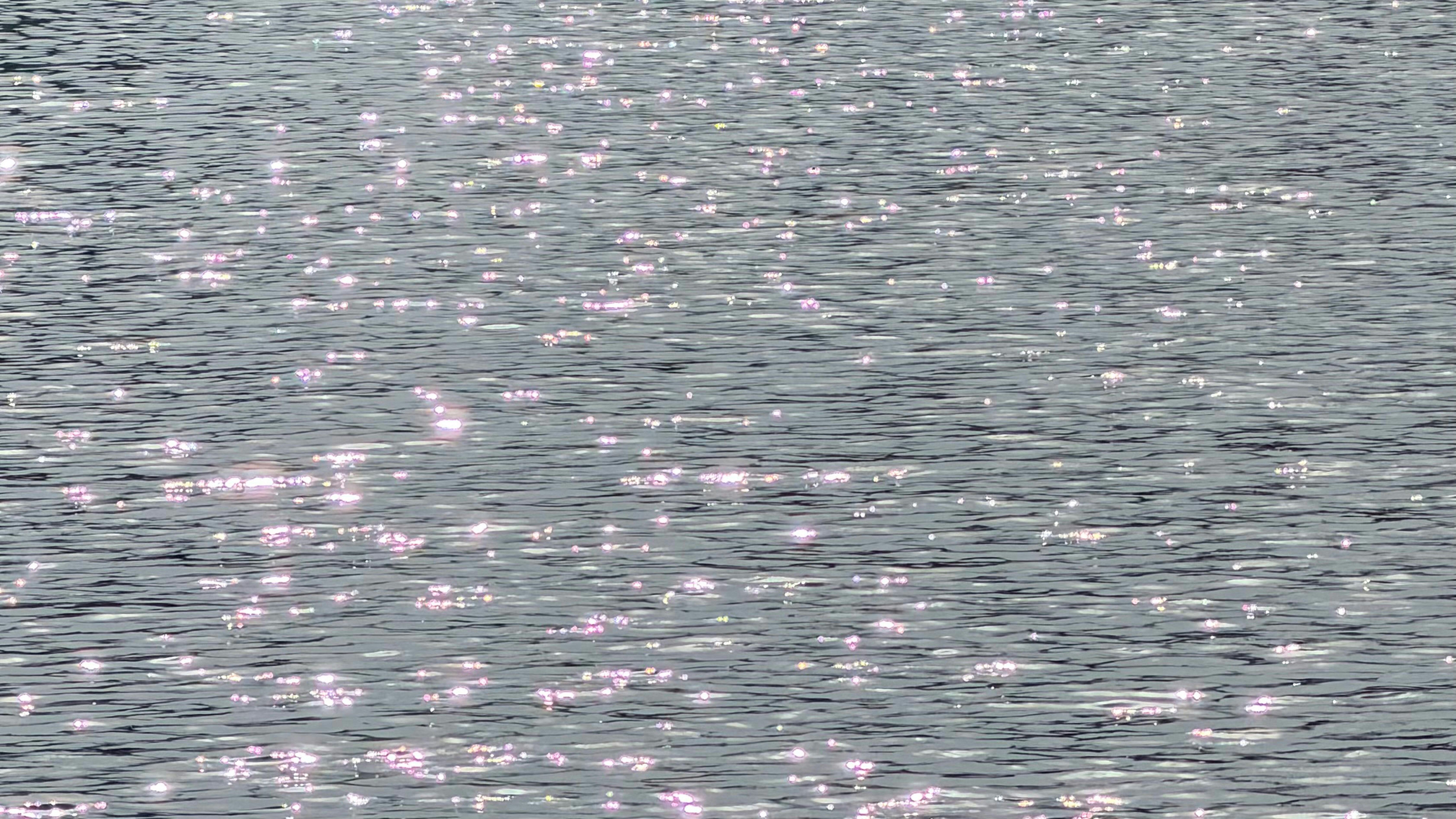 Sunlight reflecting off the surface of rippling dark water