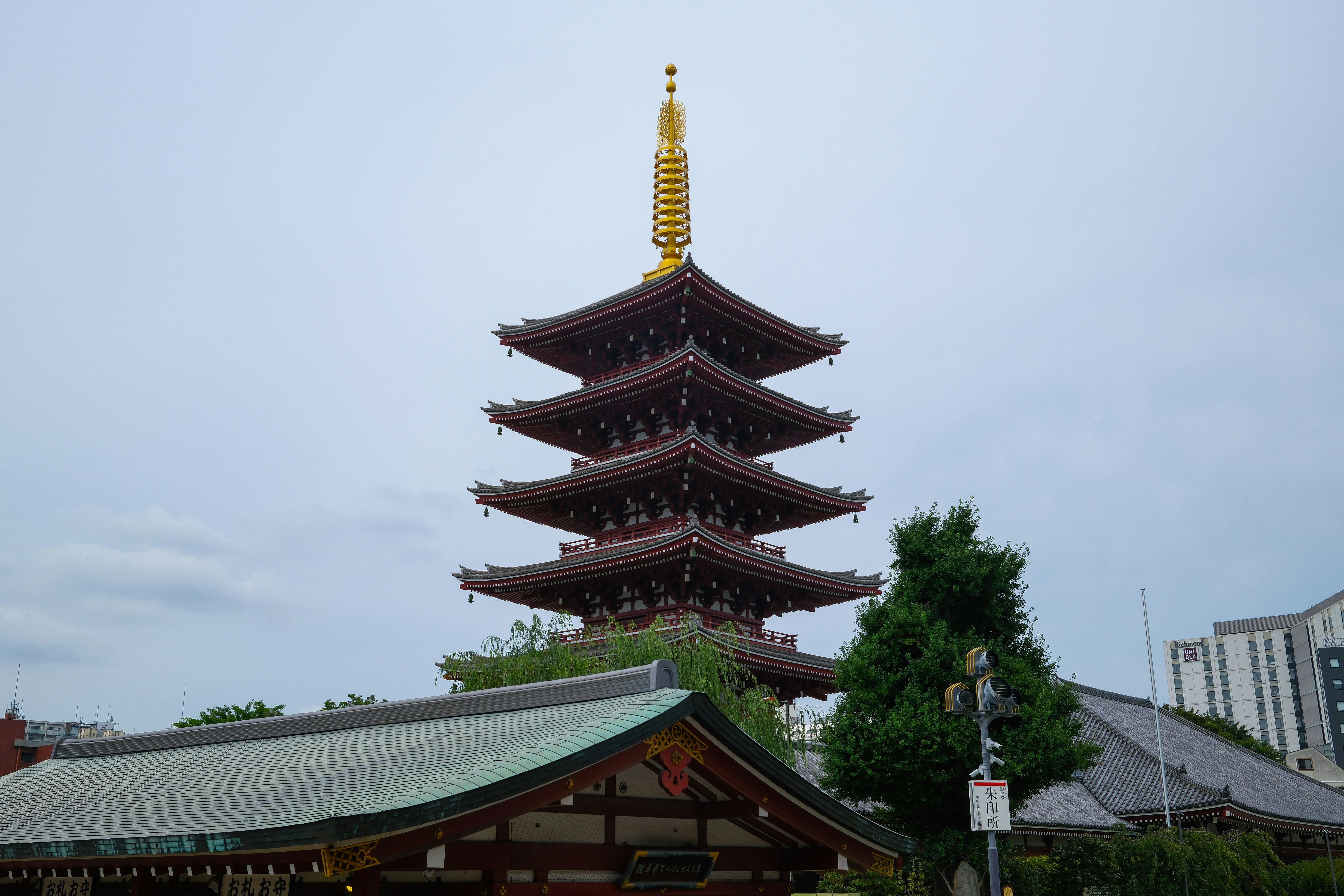 A five-story red pagoda with a gold spire in Tokyo, Japan