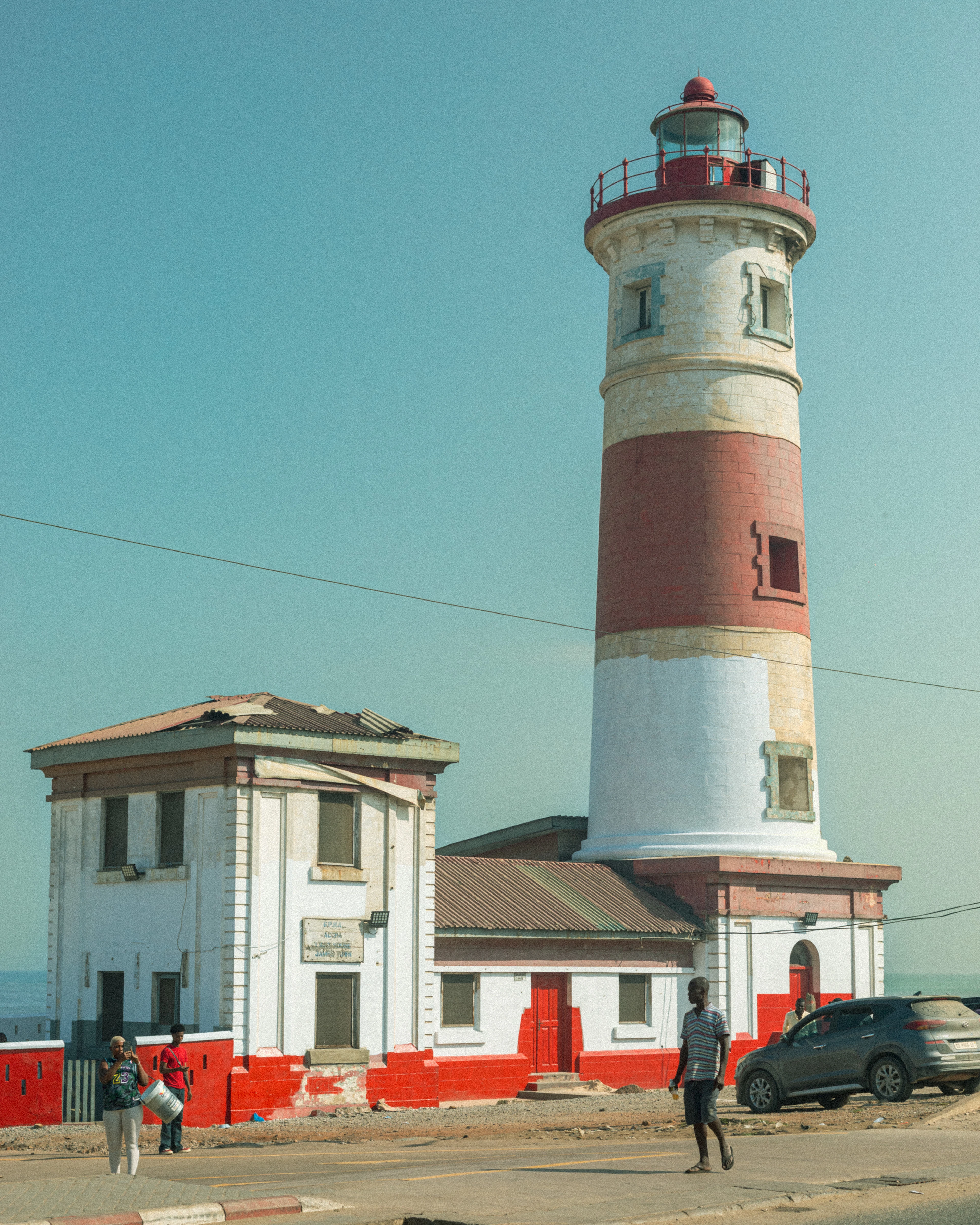 The red-and-white banded lighthouse above the rooftops of Jamestown in Accra