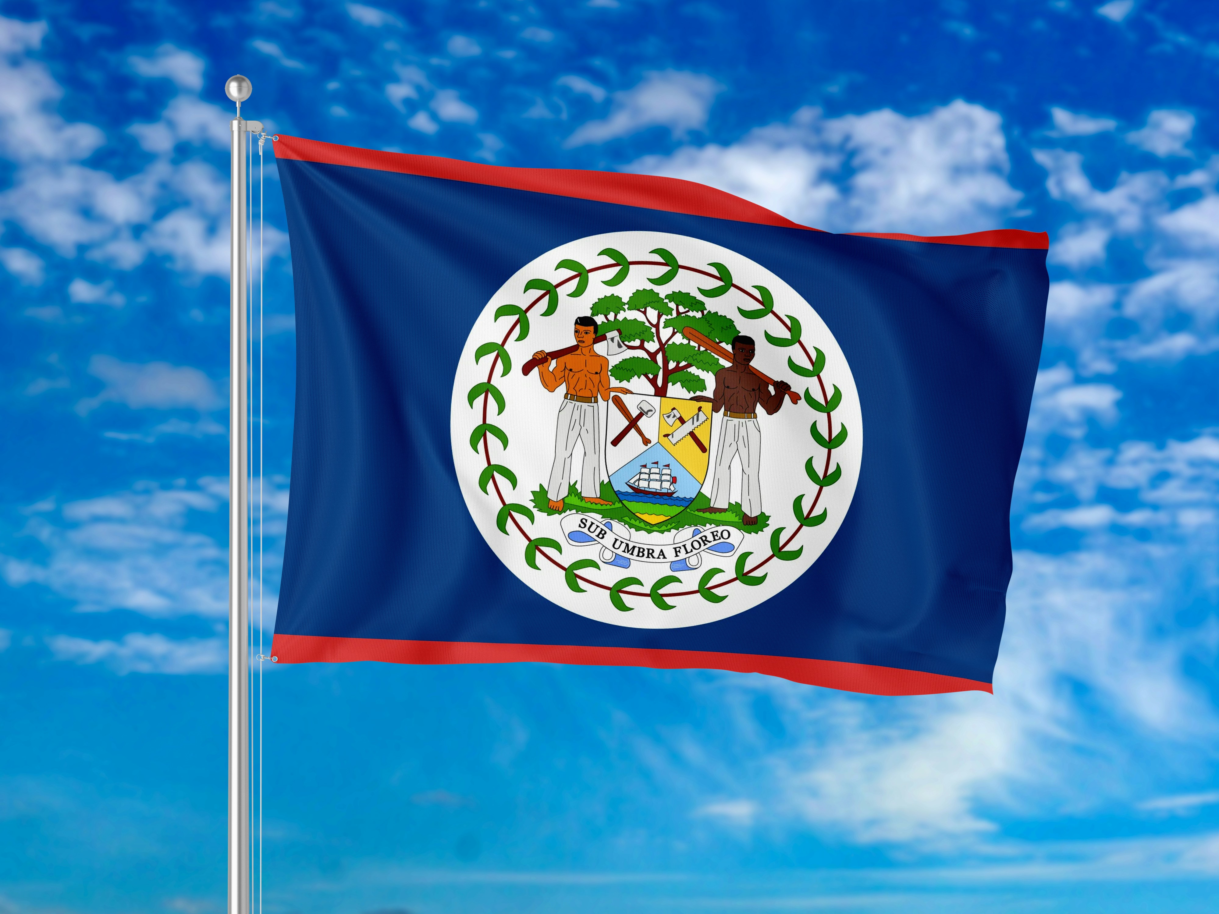 Bendera nasional Belize berkibar di langit biru cerah dengan awan
