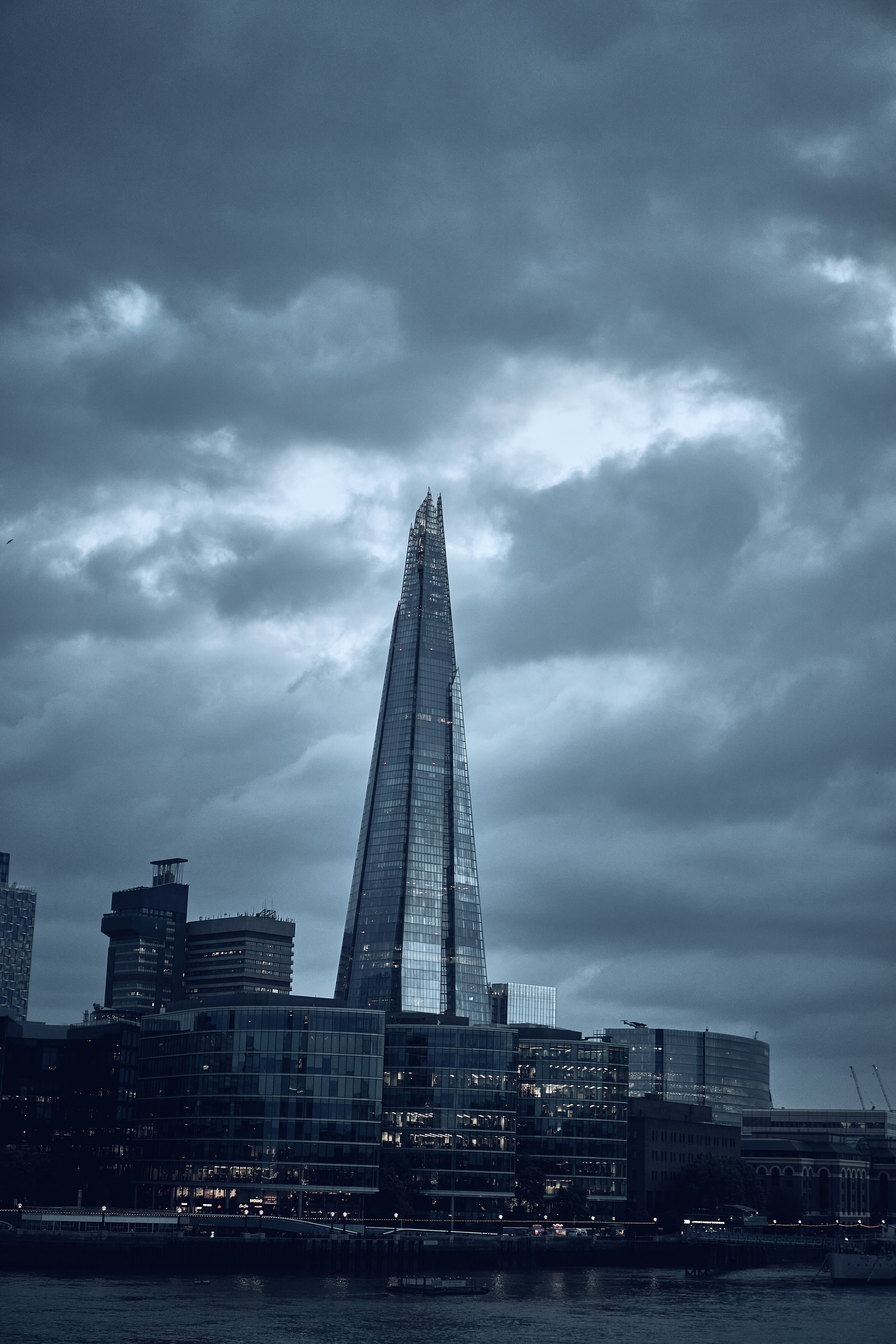 The Shard beneath dramatic clouds in London, England.