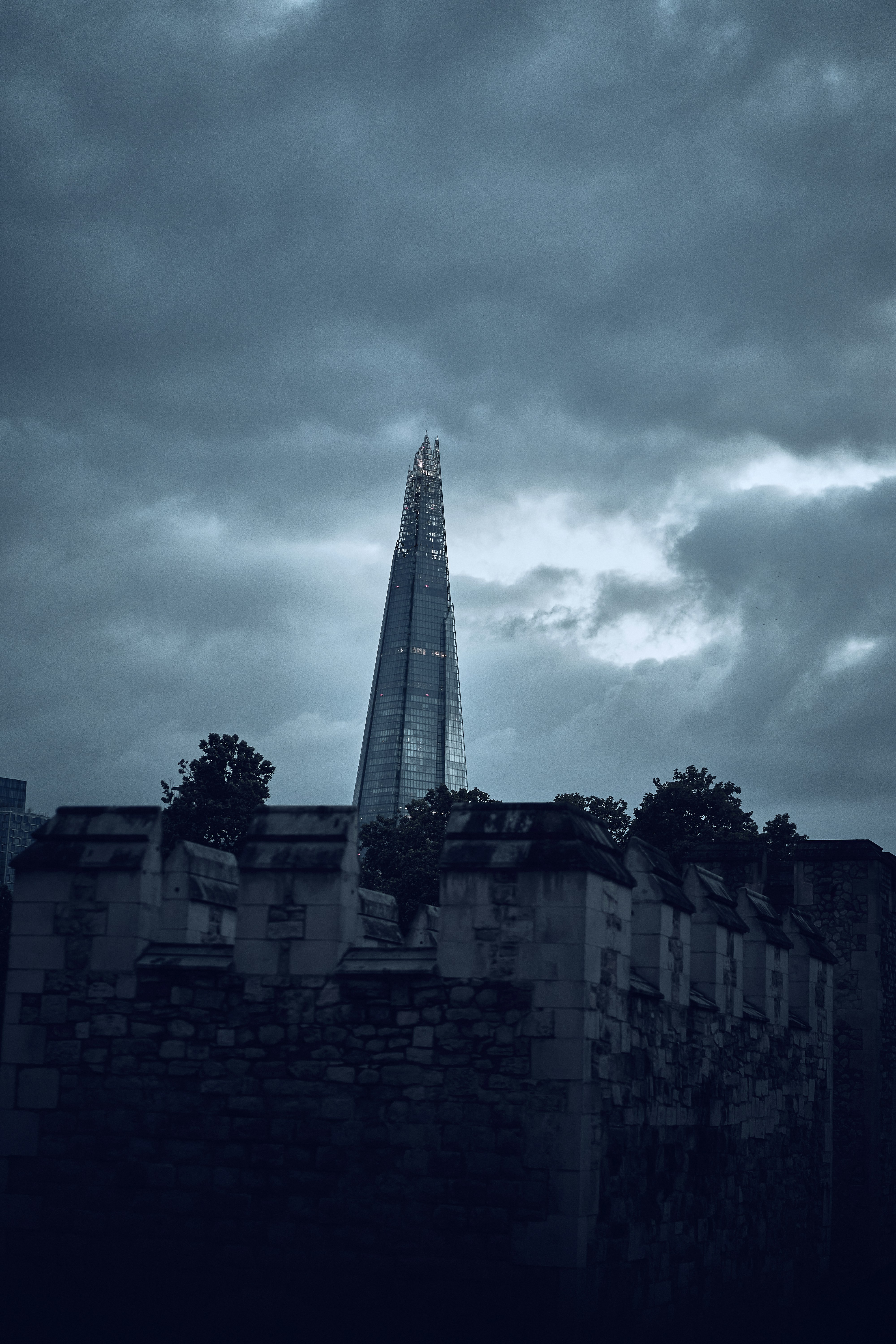 The Shard beneath dramatic clouds in London, England.