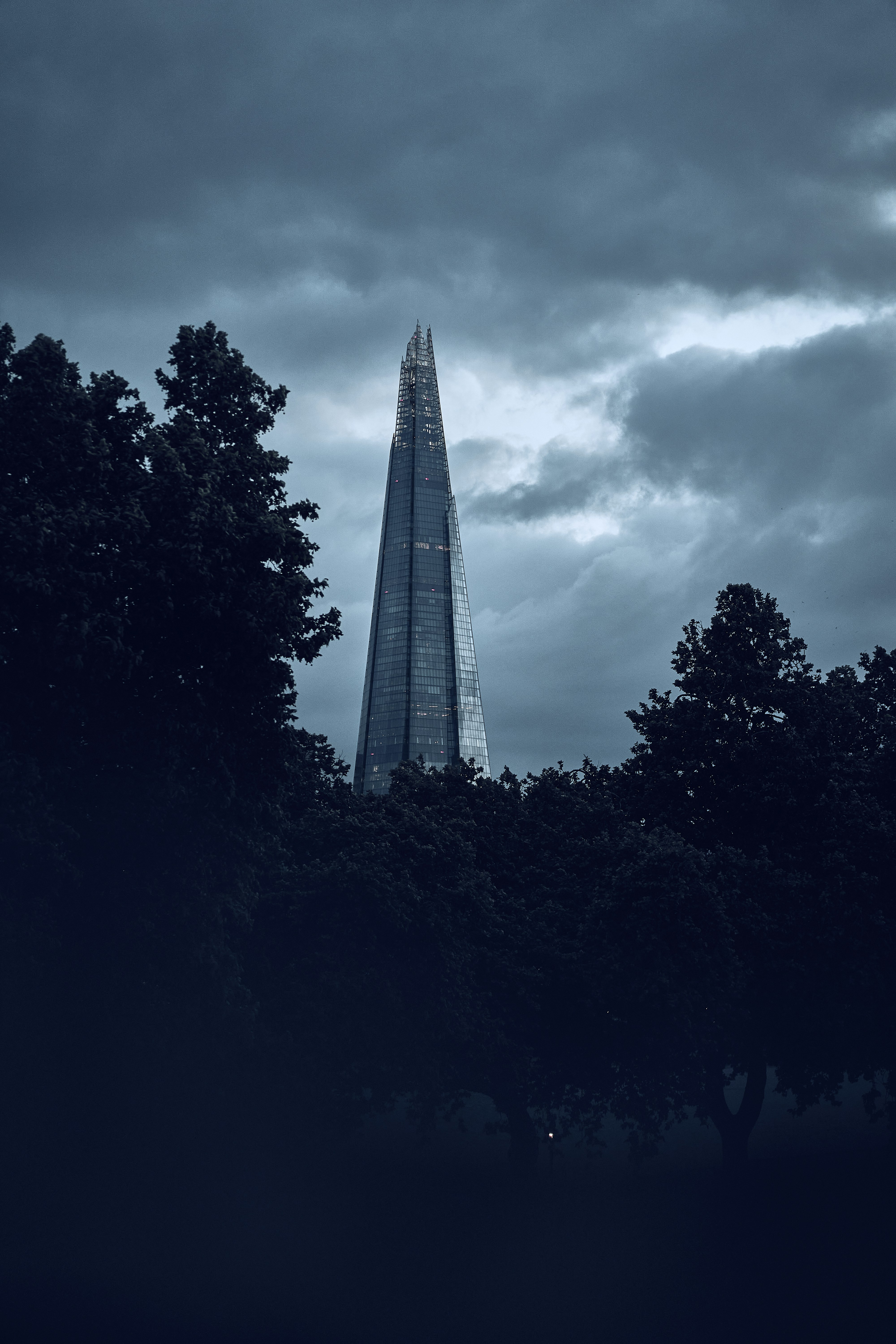 The Shard beneath dramatic clouds in London, England.