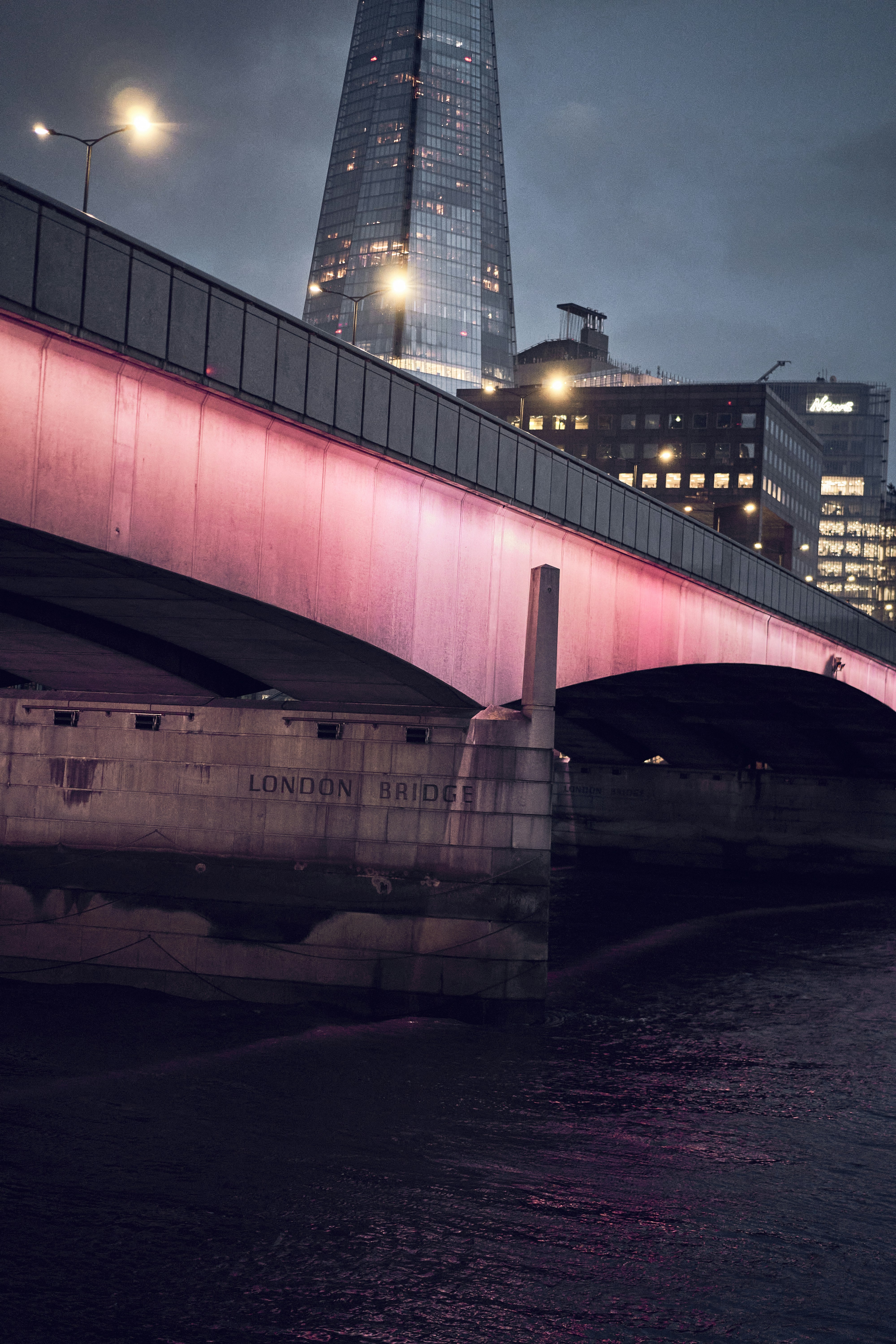 London Bridge and the River Thames at dusk in London, England.