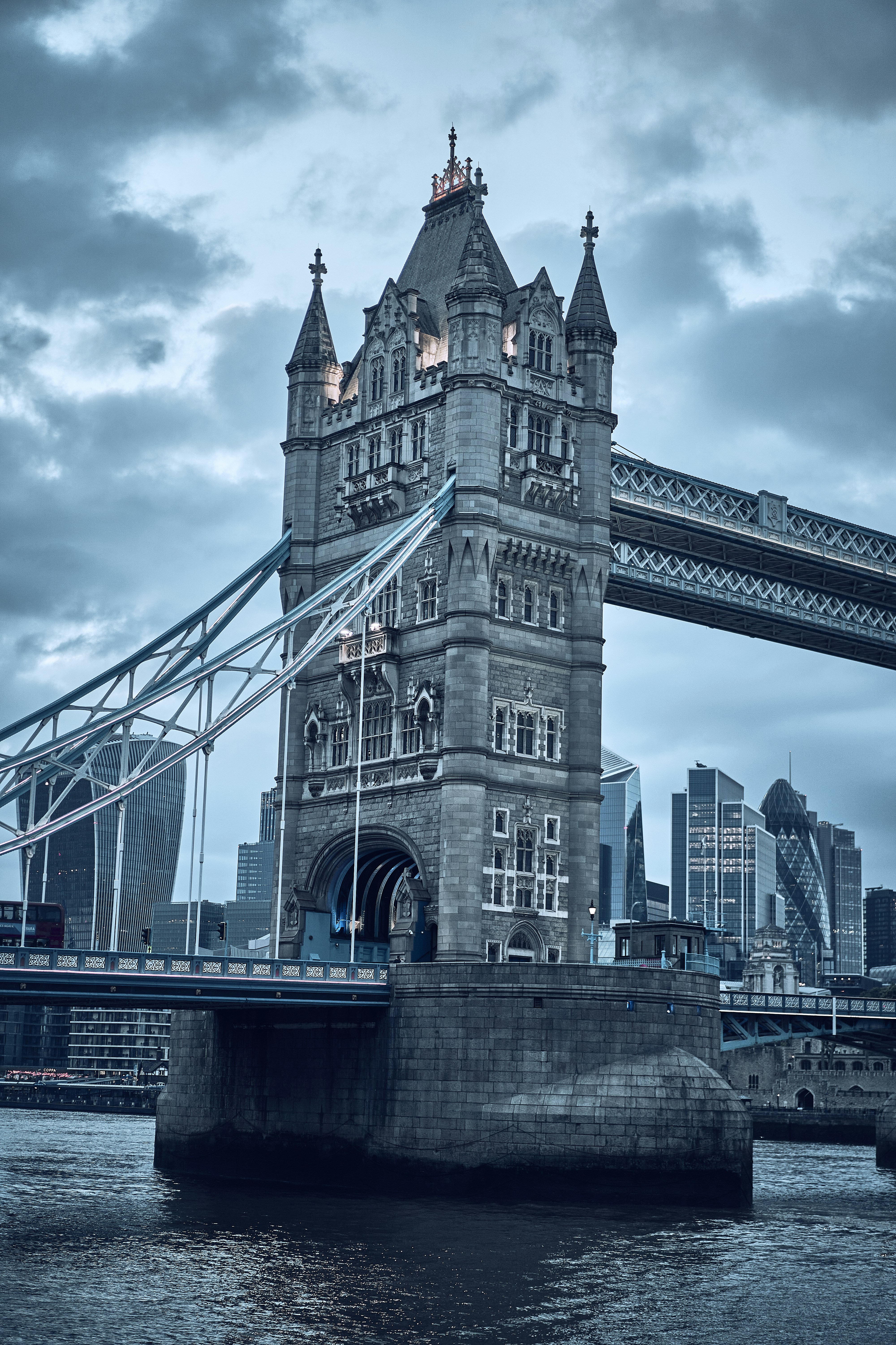 Tower Bridge beneath dramatic clouds in London, England.