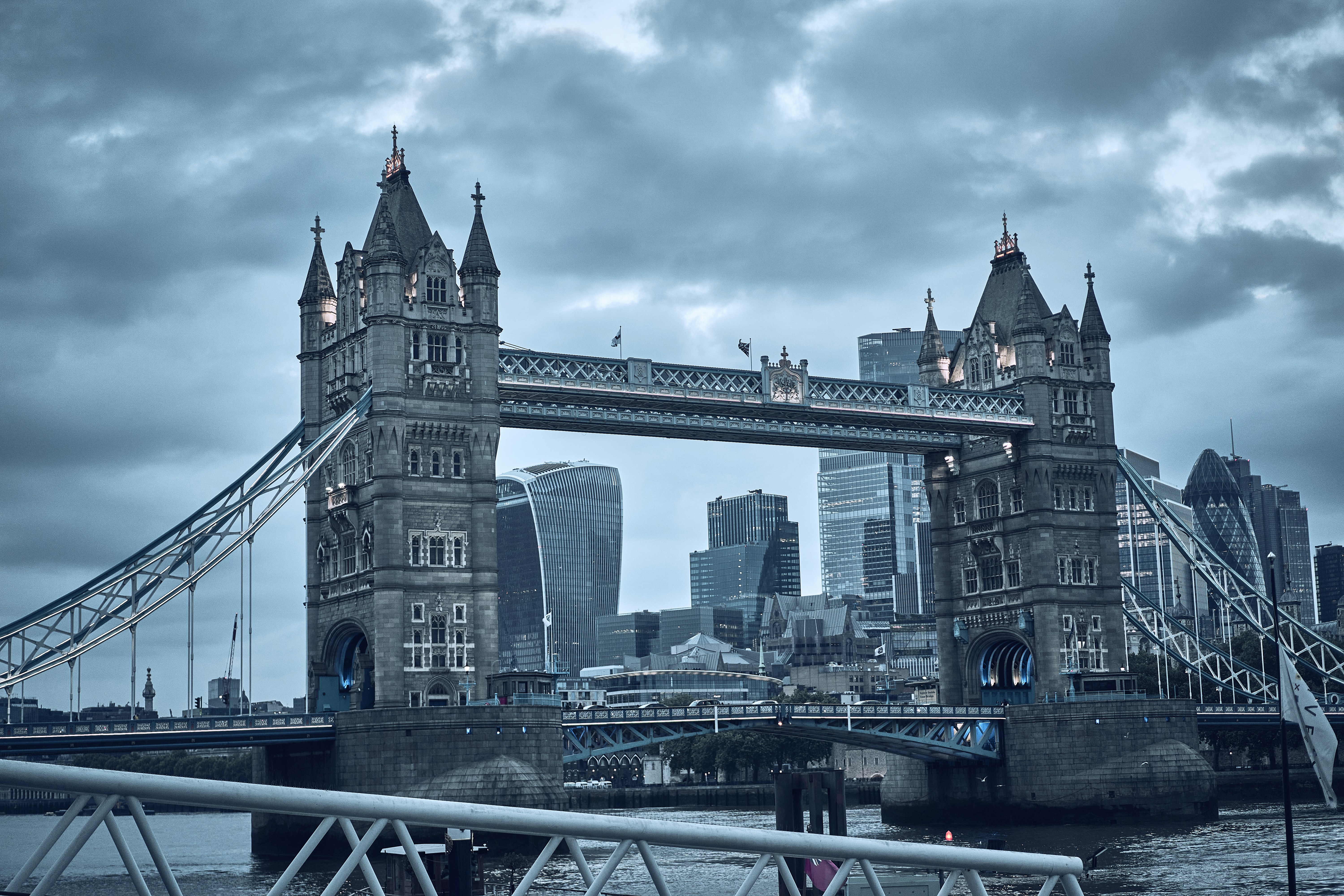 Tower Bridge beneath dramatic clouds in London, England.