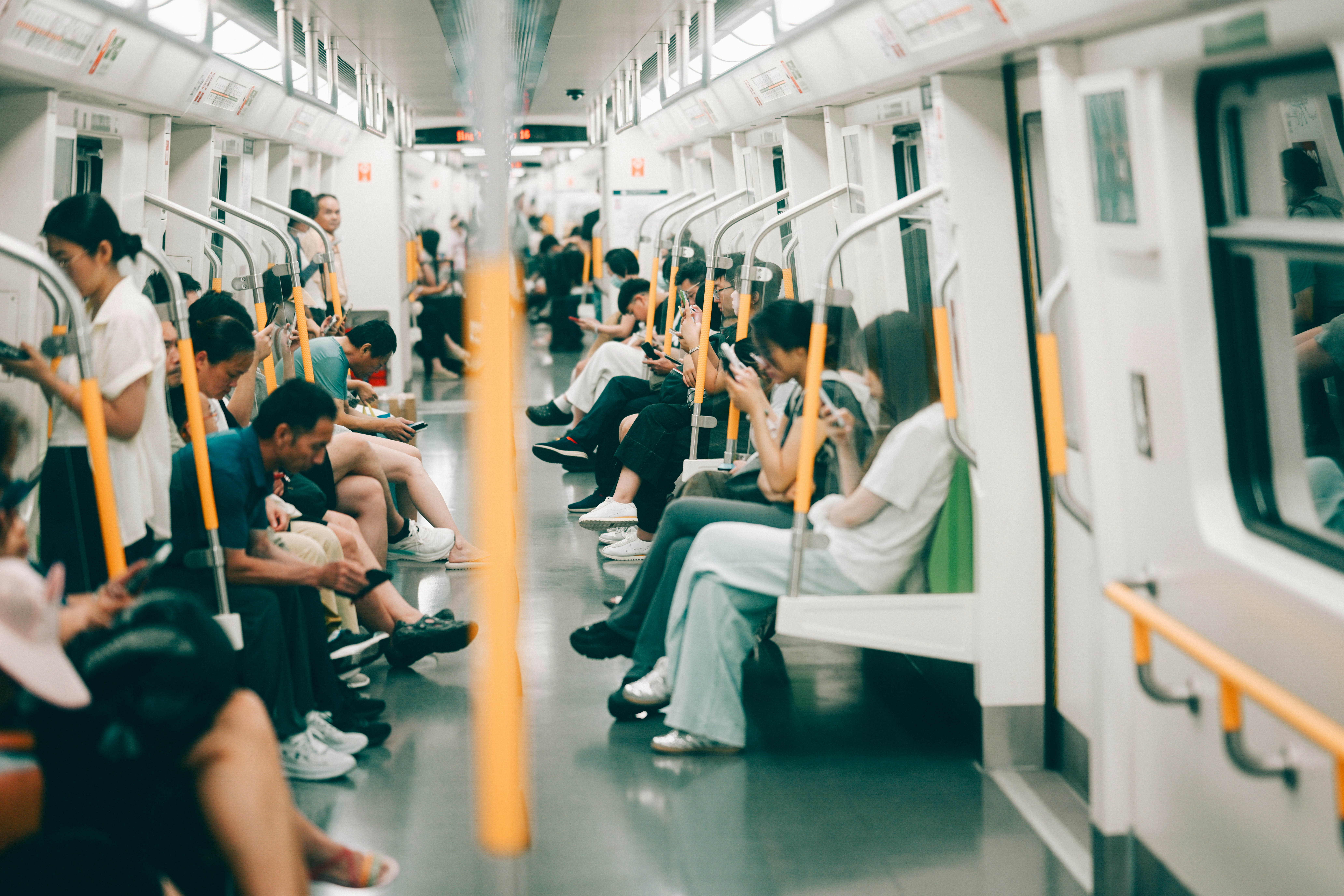 Passengers seated in a busy train carriage