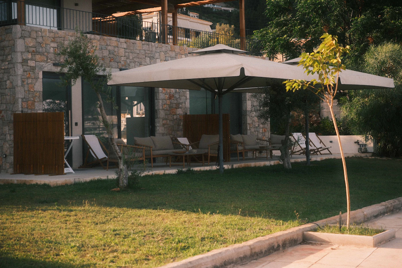 Outdoor patio furniture beside a stone villa