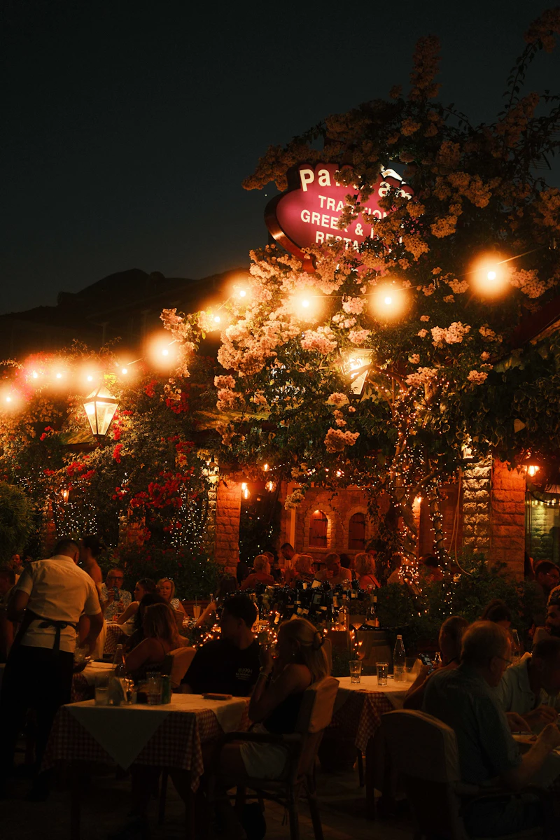 Diners on a terrace under string lights