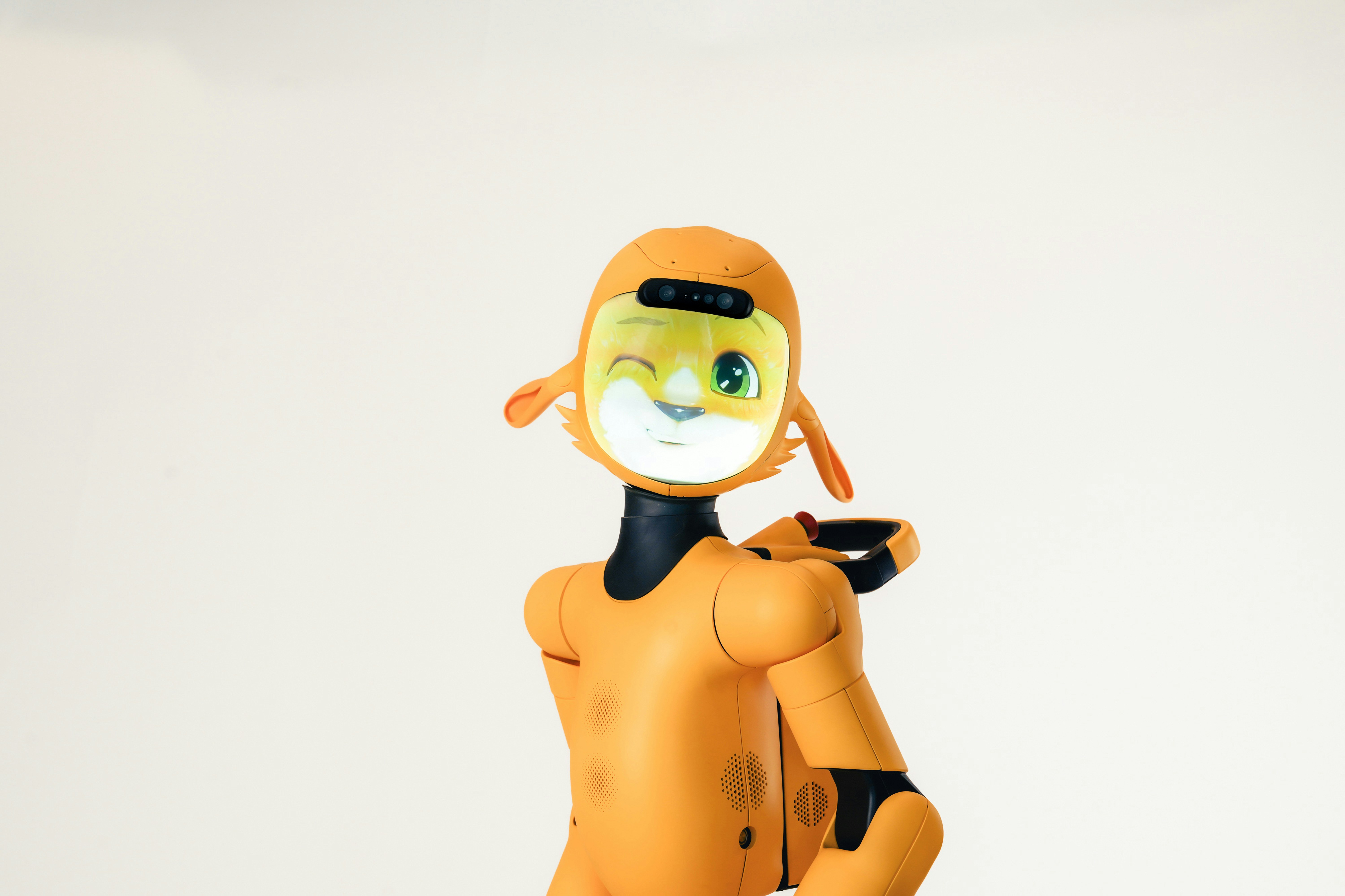 An orange robot with a digital face winking against a plain white background