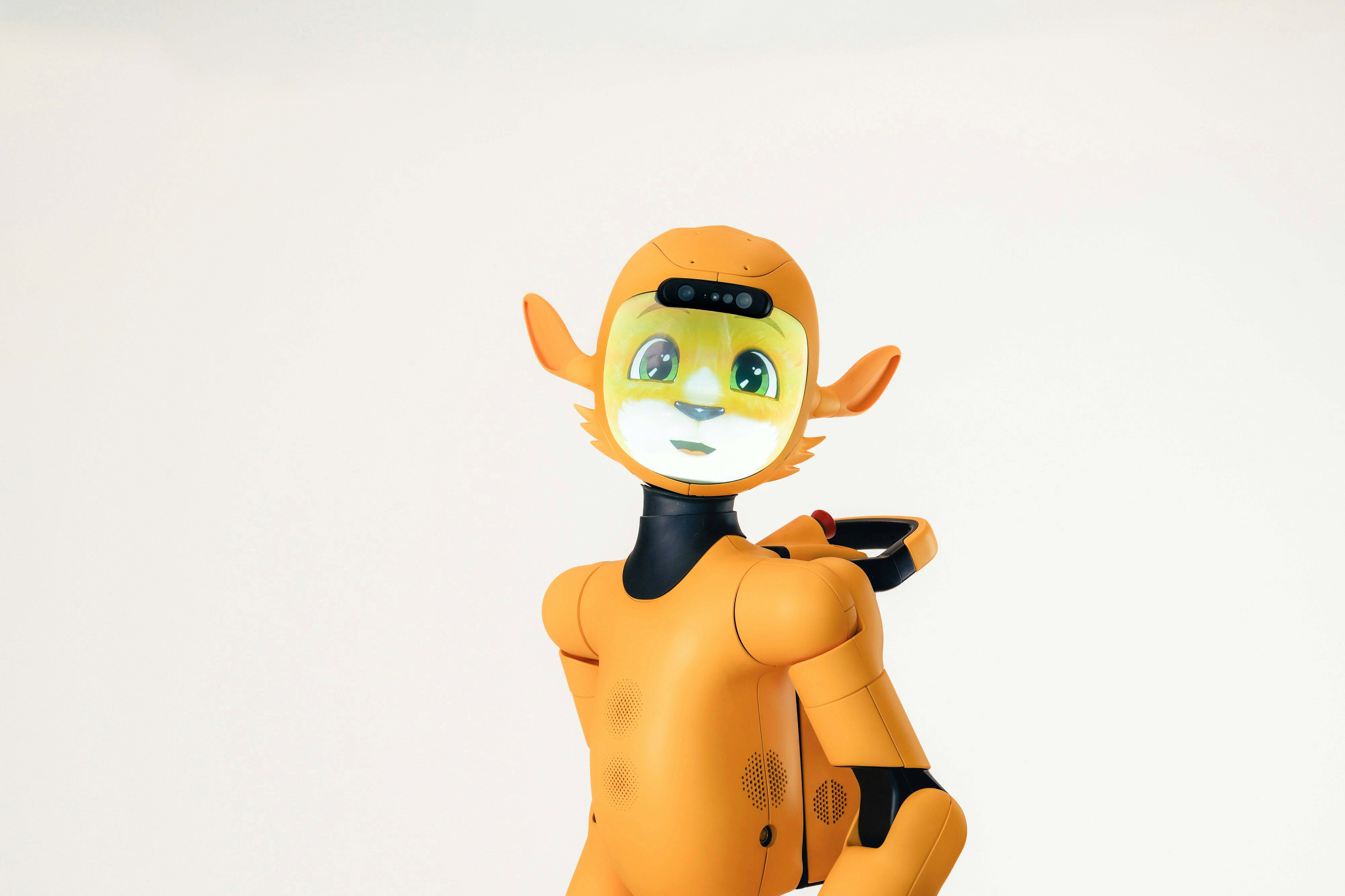 An orange humanoid robot with a digital screen face against a white background