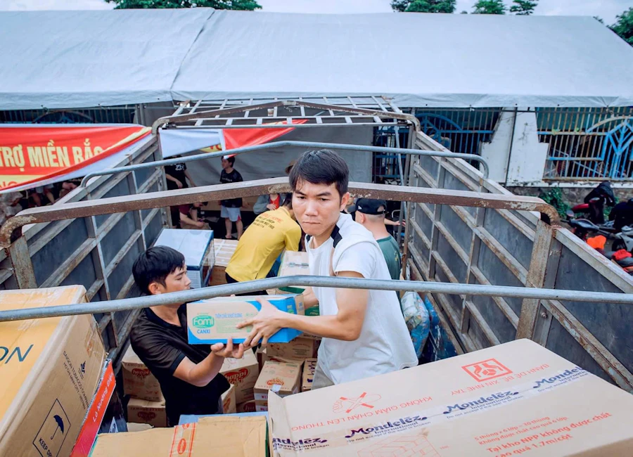 Volunteers loading aid boxes into a truck