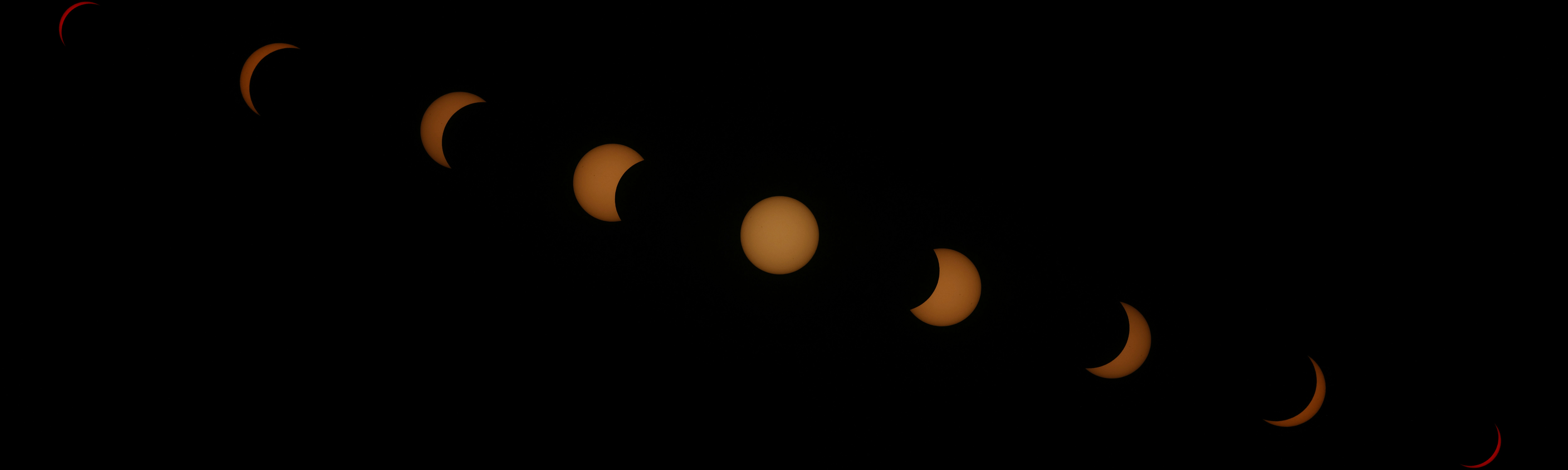 A sequence of solar eclipse phases showing the moon passing across the sun