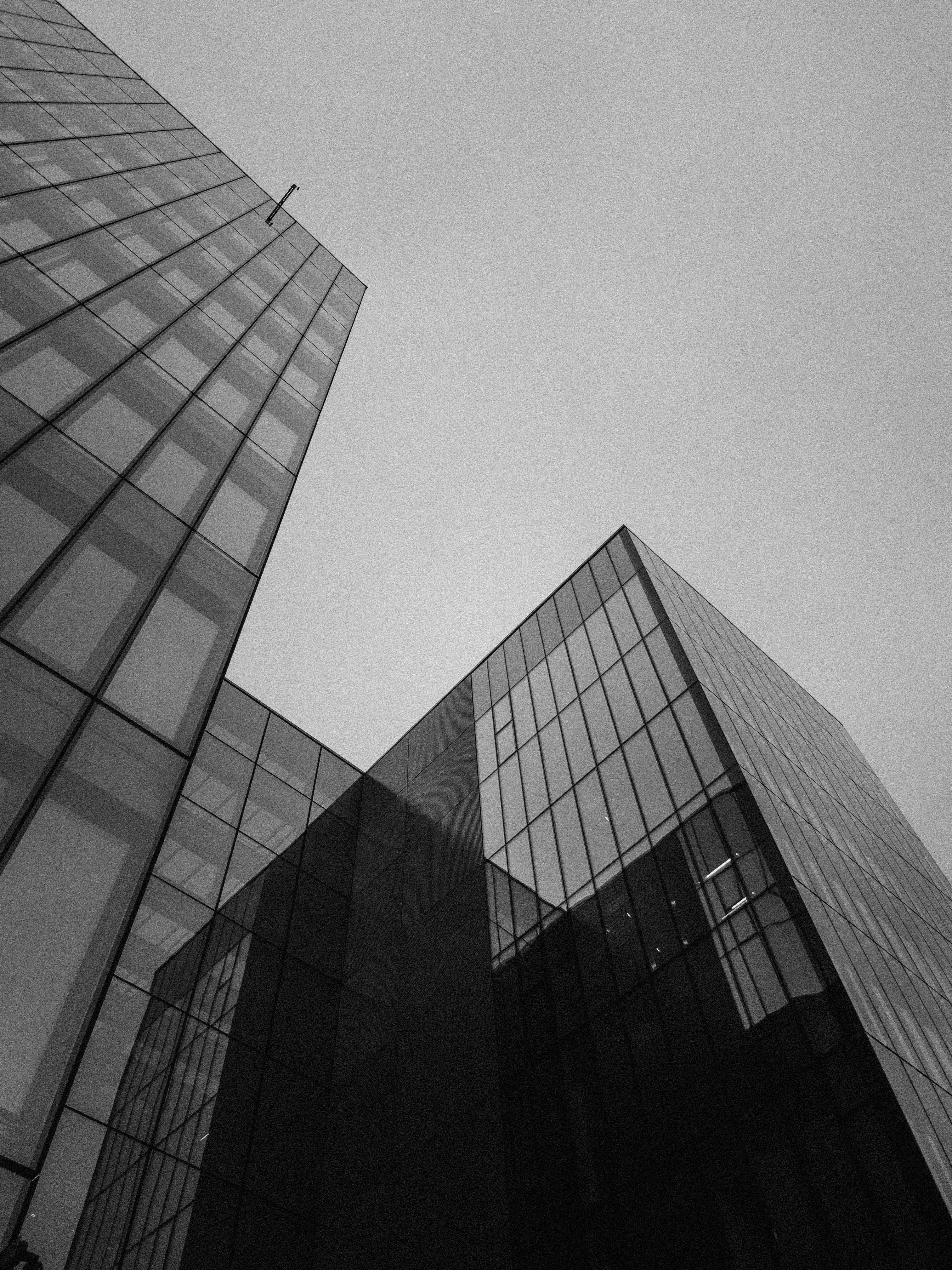 Low angle view of two modern glass skyscrapers against a clear sky