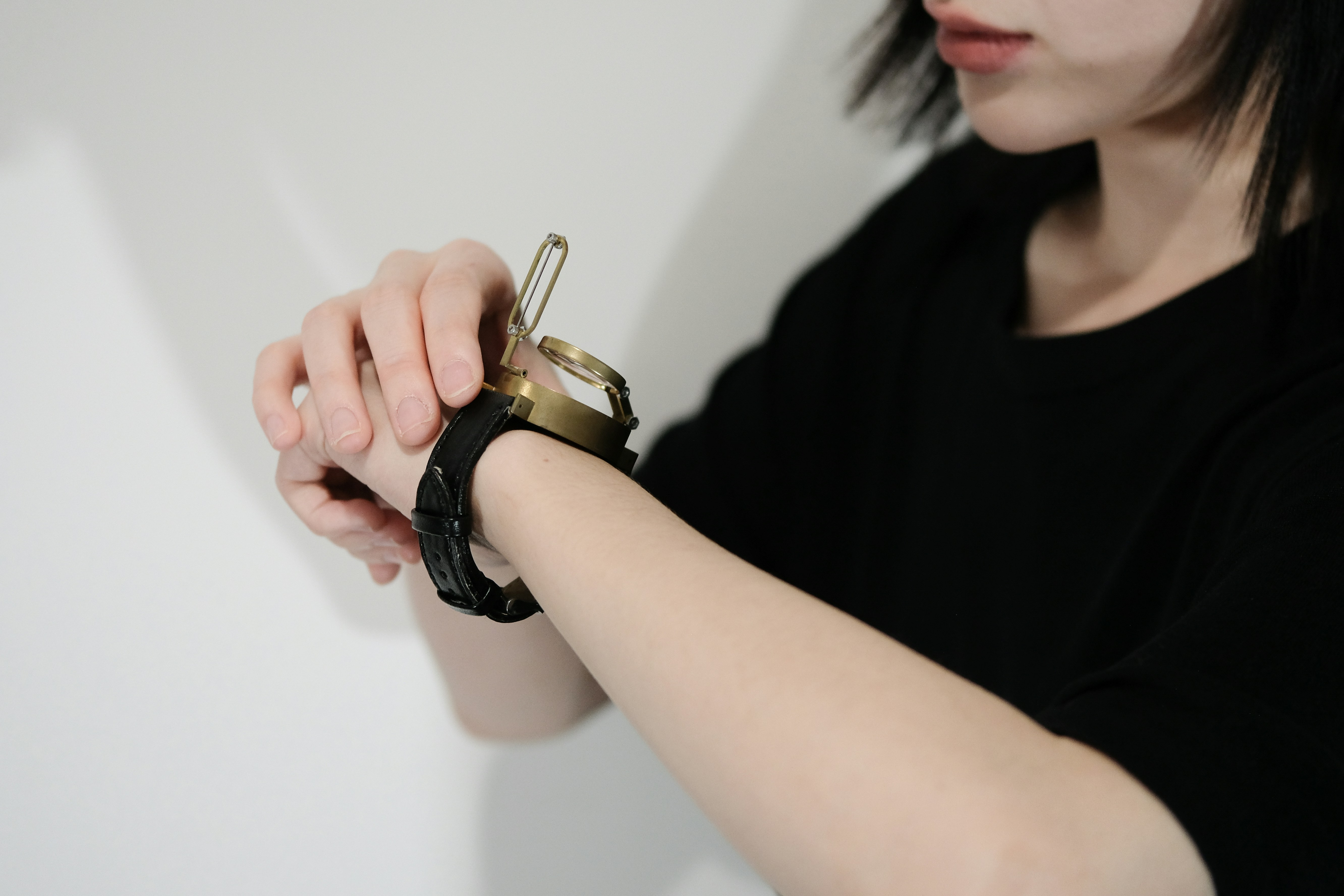 A person applying a rollerball blend to their wrist pulse point
