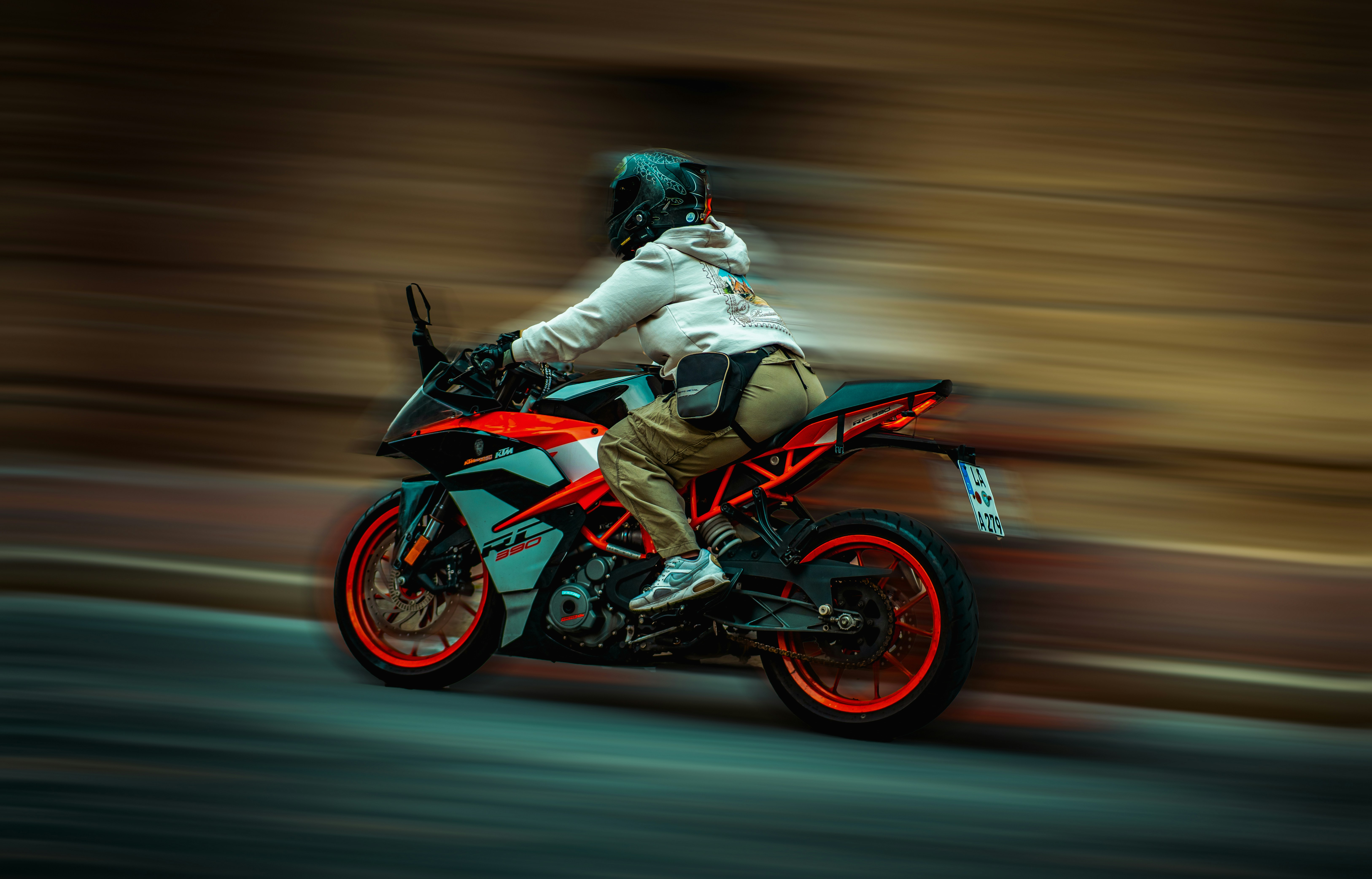 A person riding a sport motorcycle with motion blur on a city street