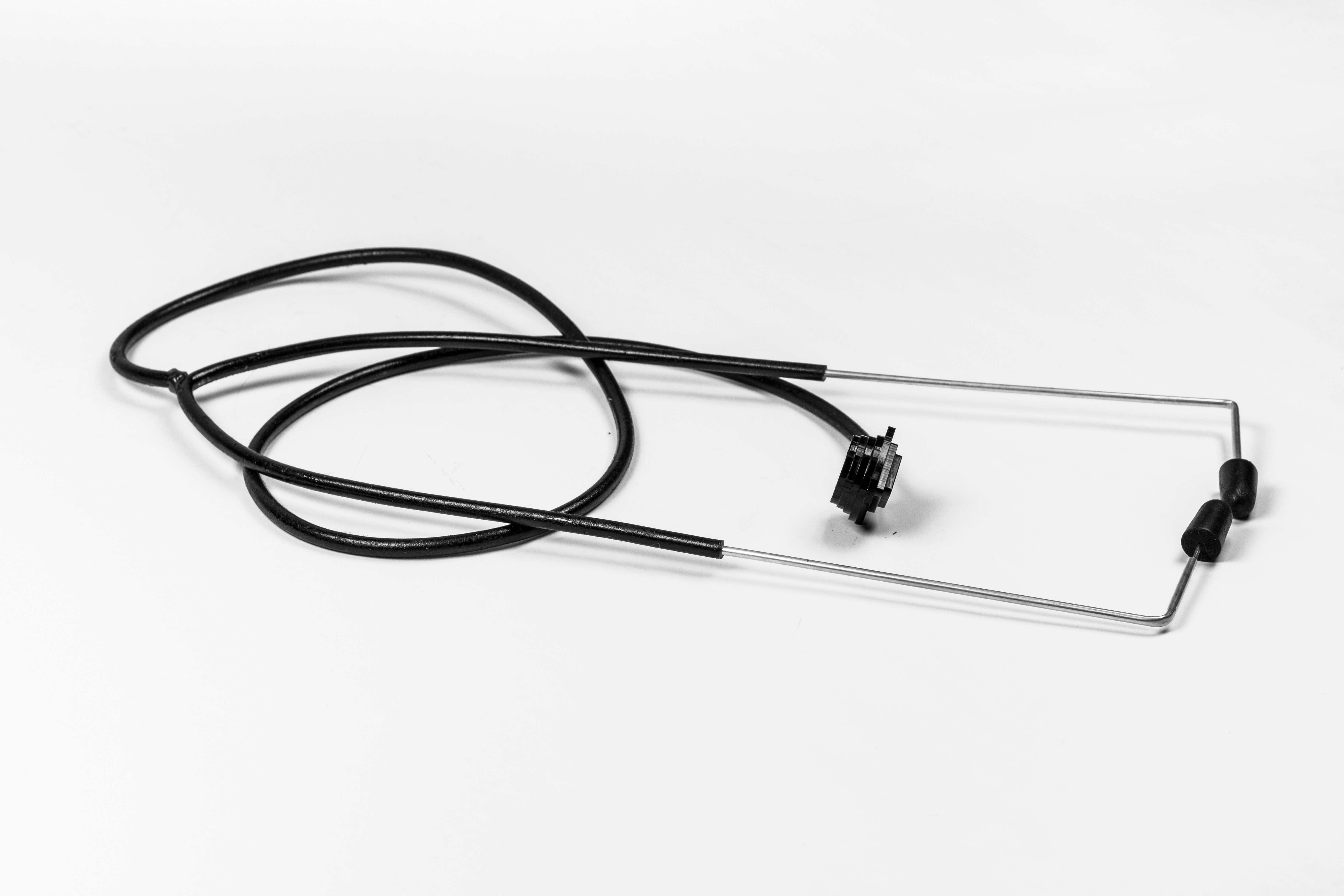 A black coiled cable attached to a metal frame with two small earpieces