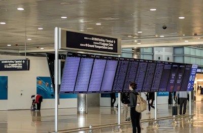 A traveller reading the departures board in an airport