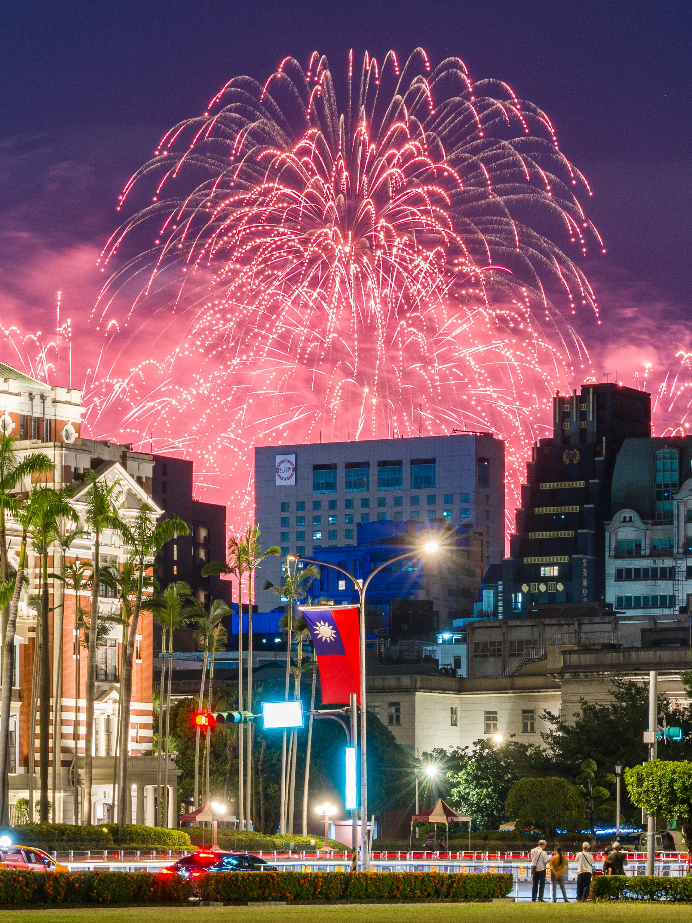 Red fireworks exploding over the city skyline of Taipei at night