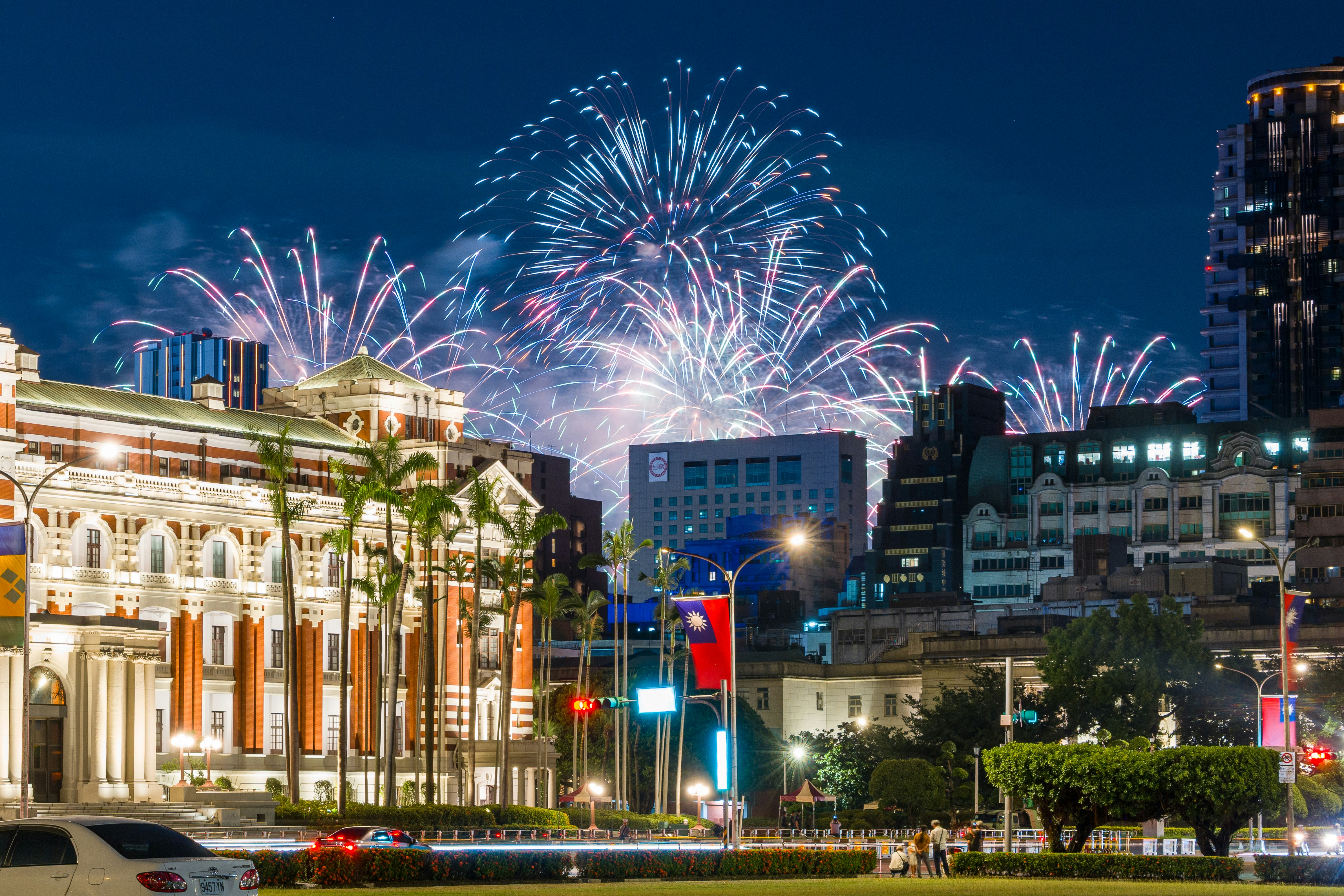Fireworks exploding over the National Taiwan Museum and city skyline in Taipei