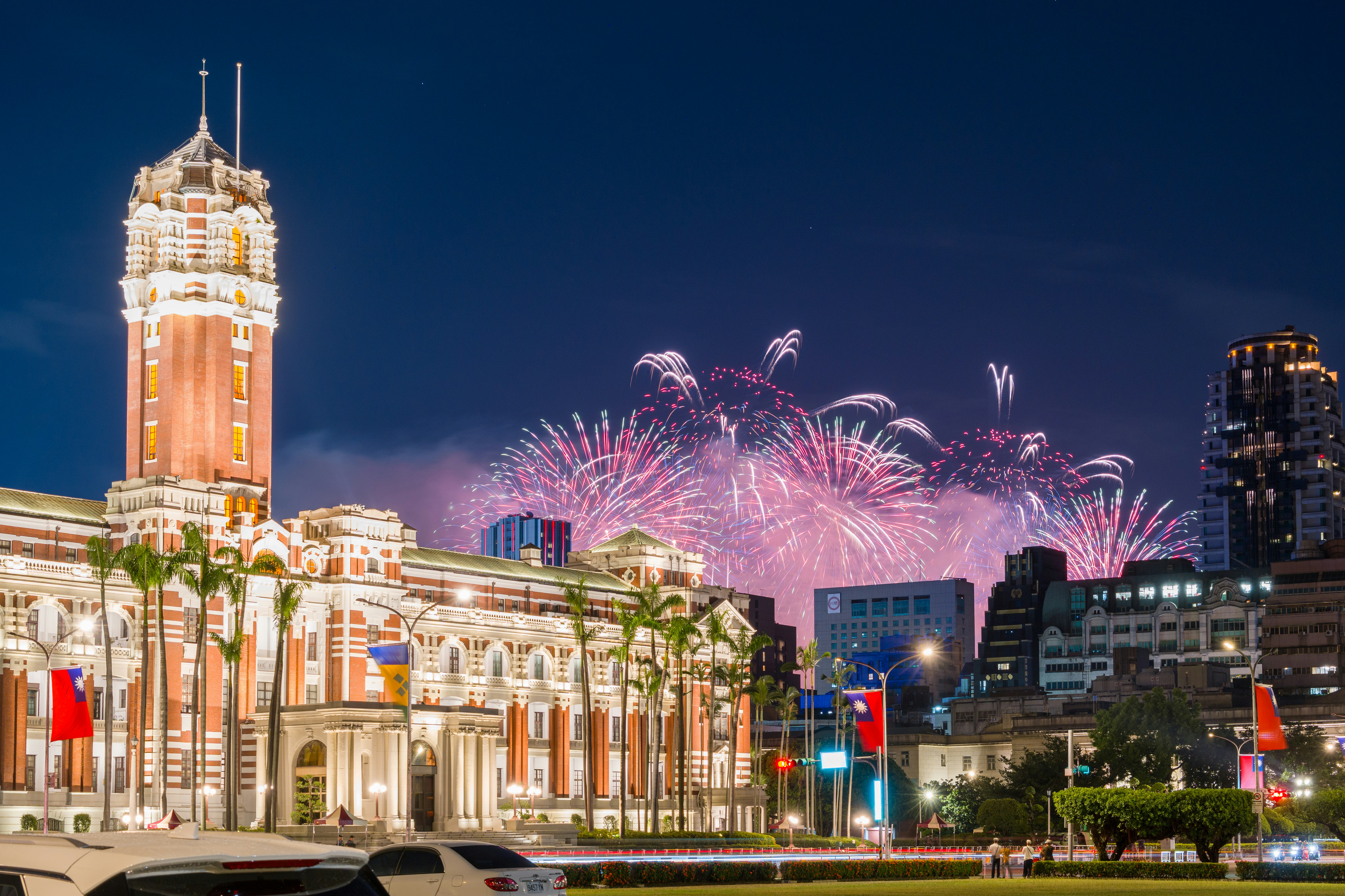 Fireworks exploding over the Presidential Office Building in Taipei at night
