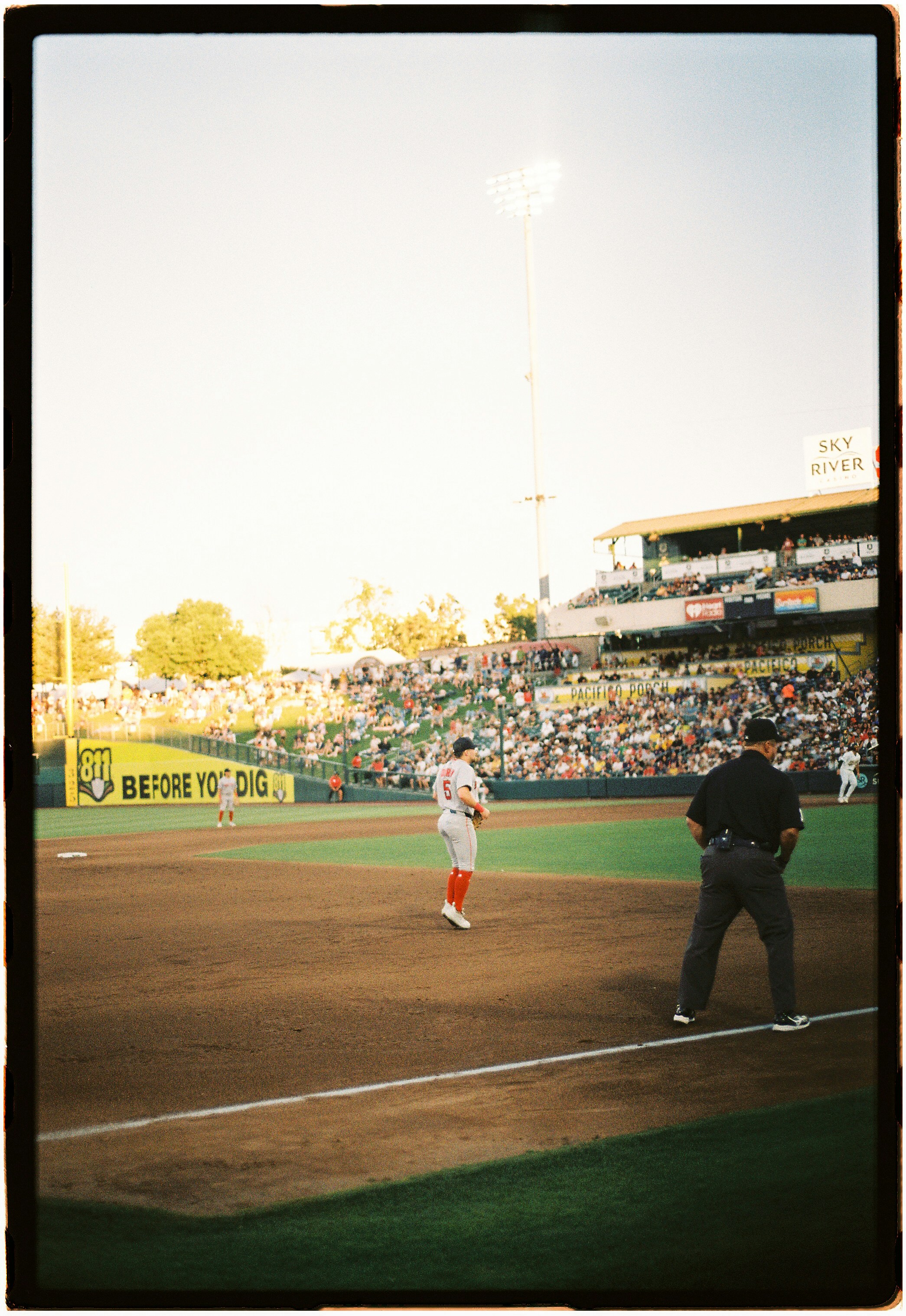 A baseball player on the field with an umpire nearby during a game
