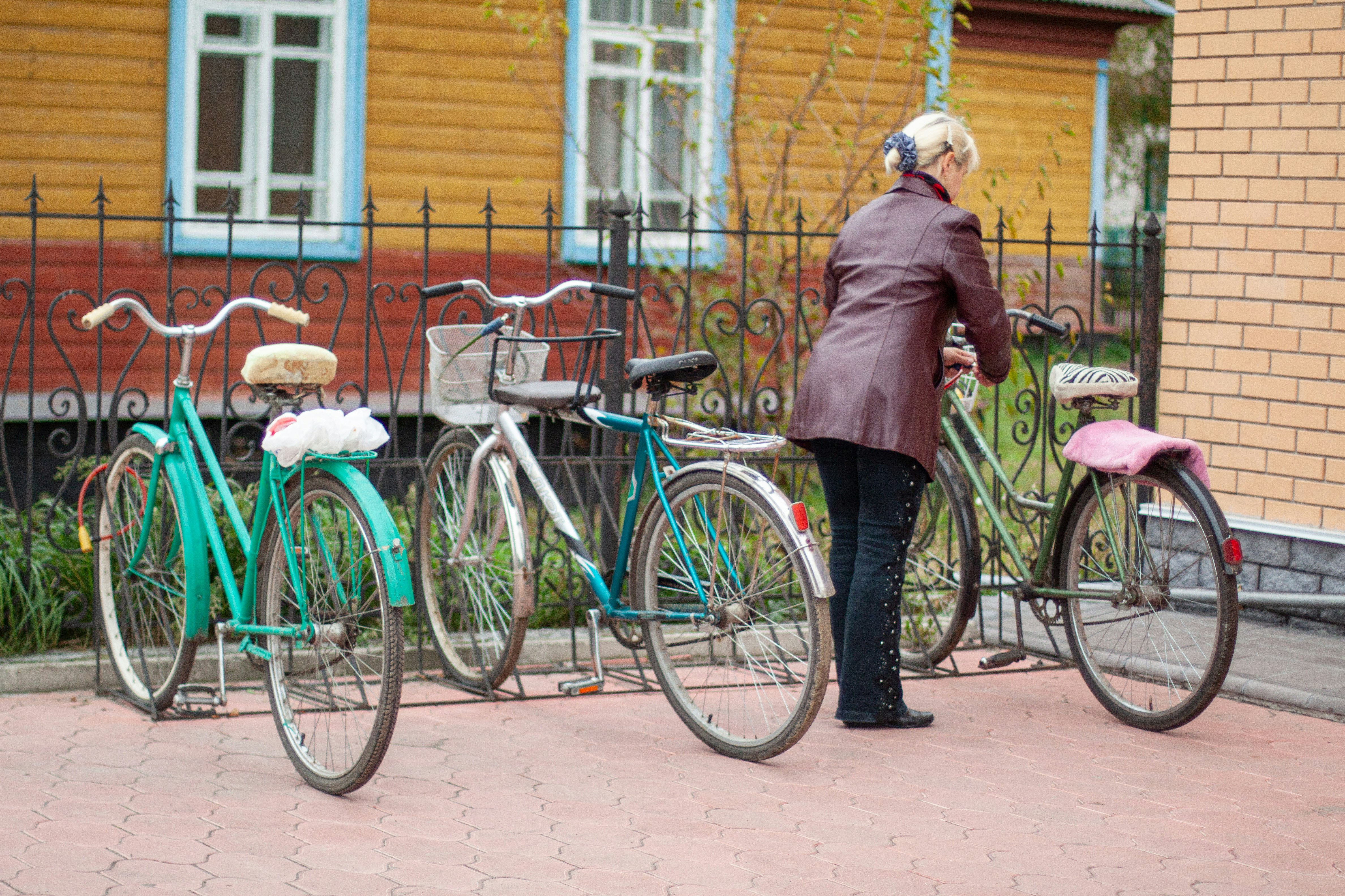Person locking a bicycle at a rack
