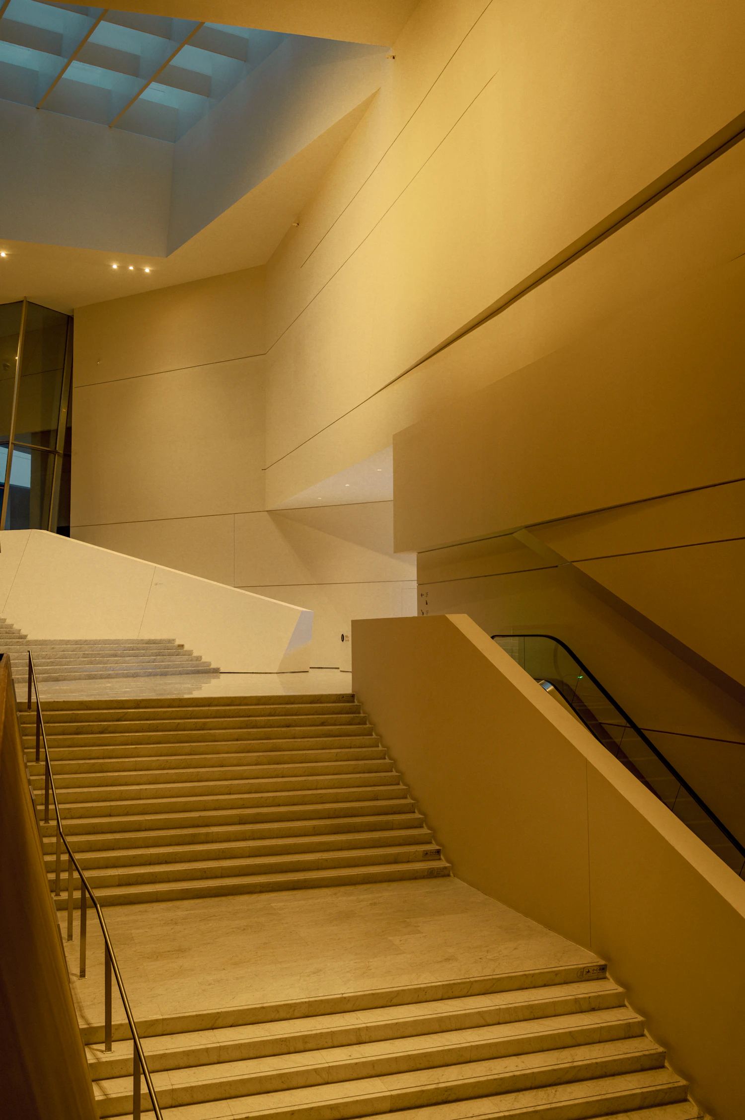 A wide stone staircase under warm light