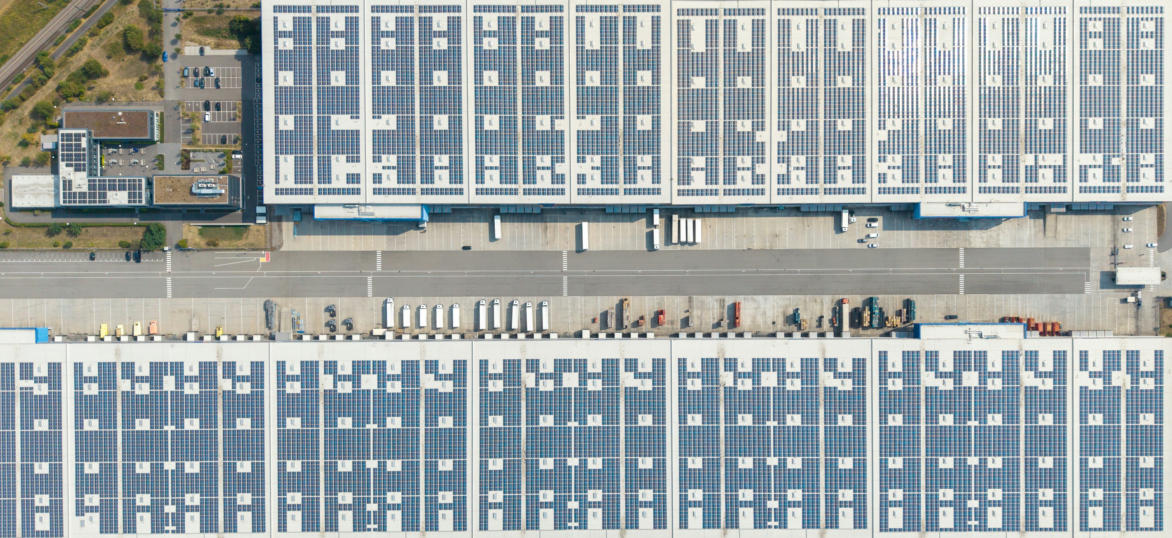 Commercial rooftop solar panel installation on an industrial building