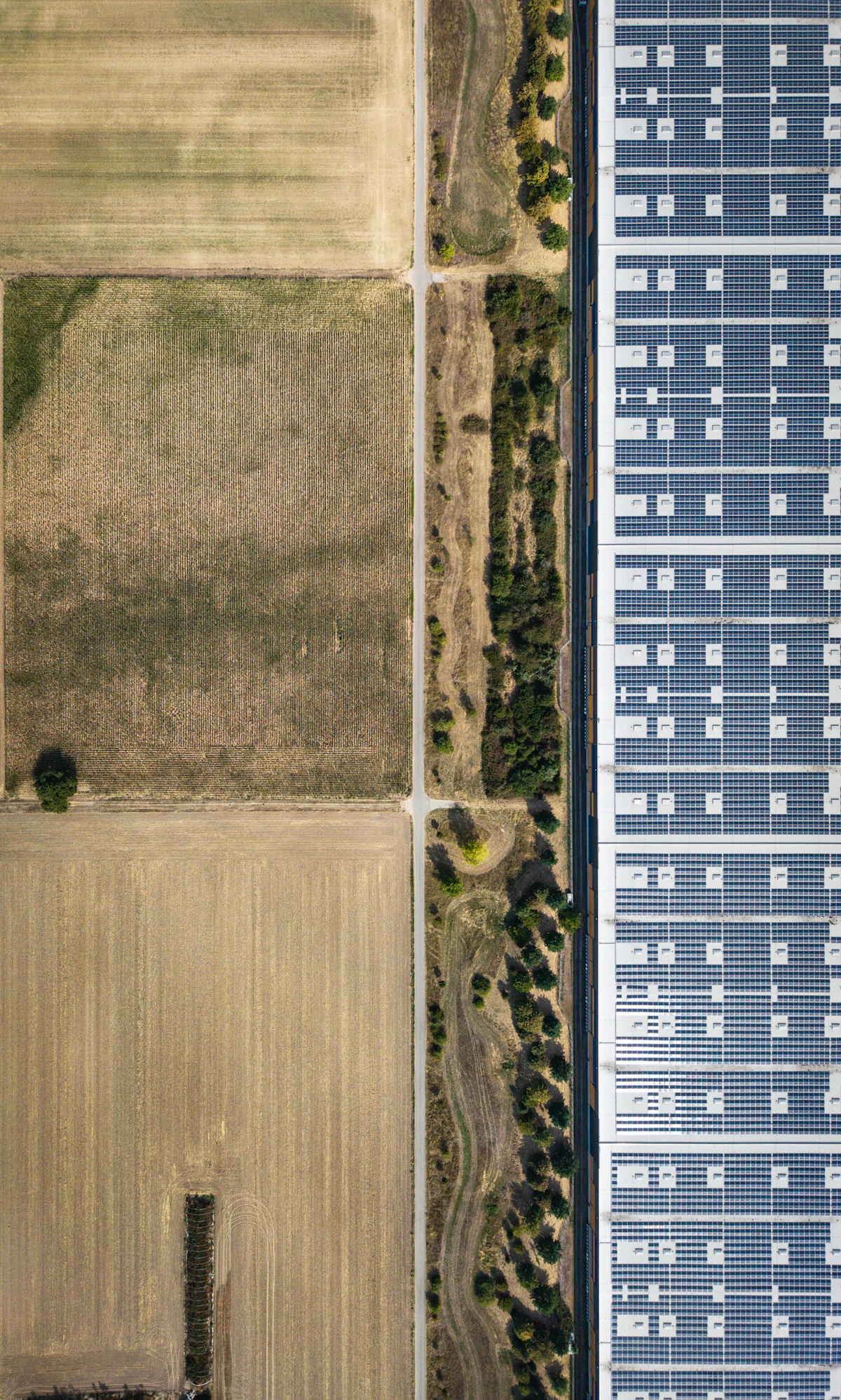 Aerial view of a solar array beside farmland